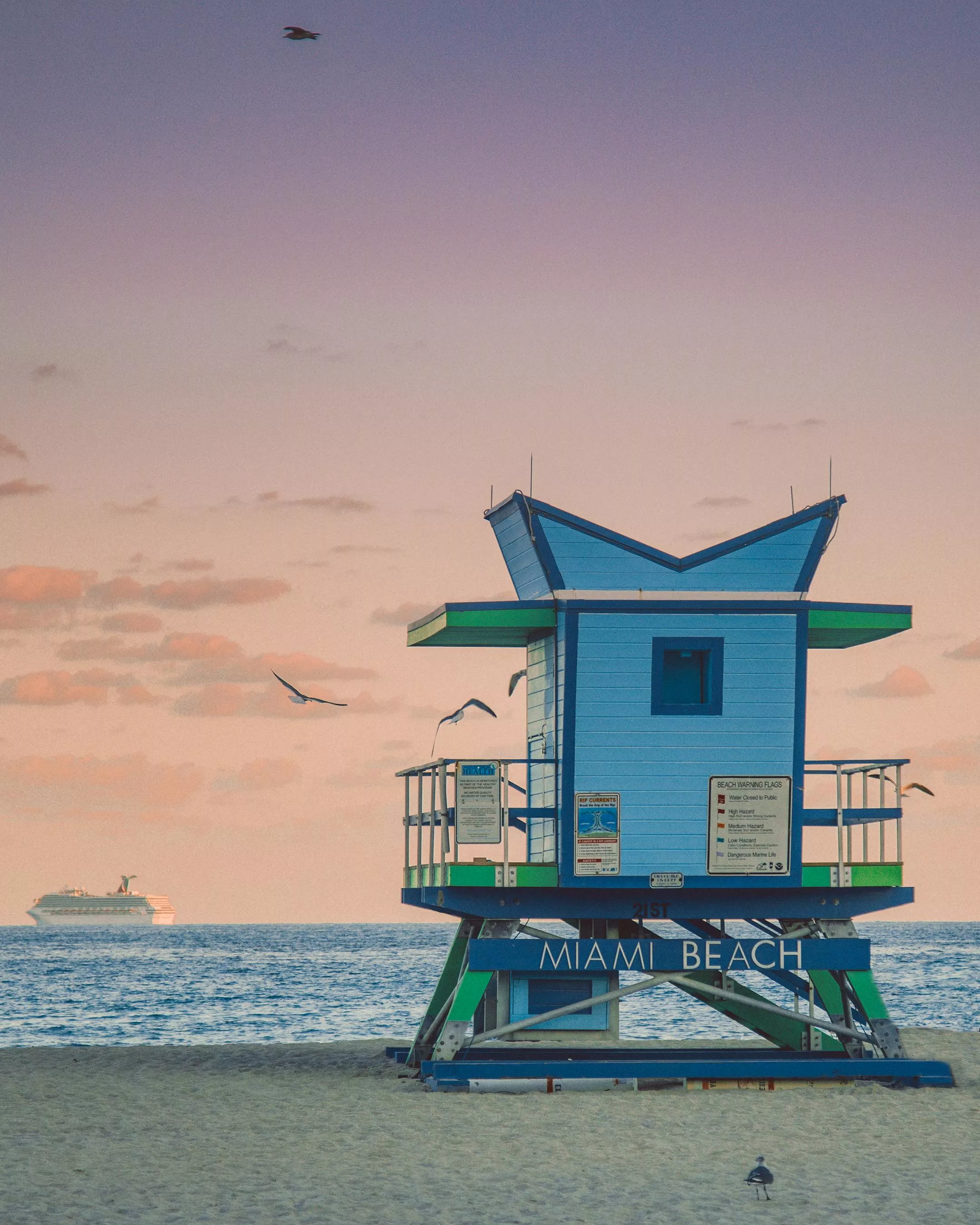 Lifeguard building on seashore against sundown sky · Free
