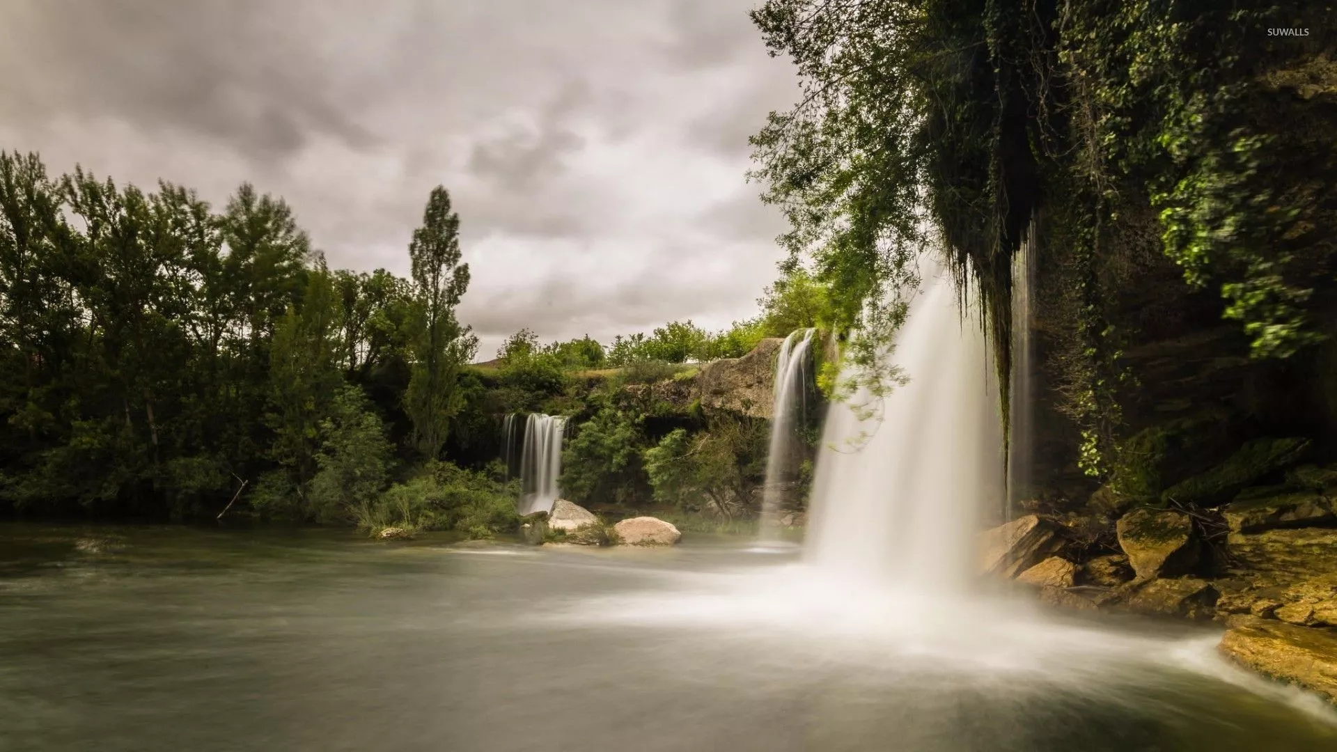 Dark clouds above the forest waterfalls