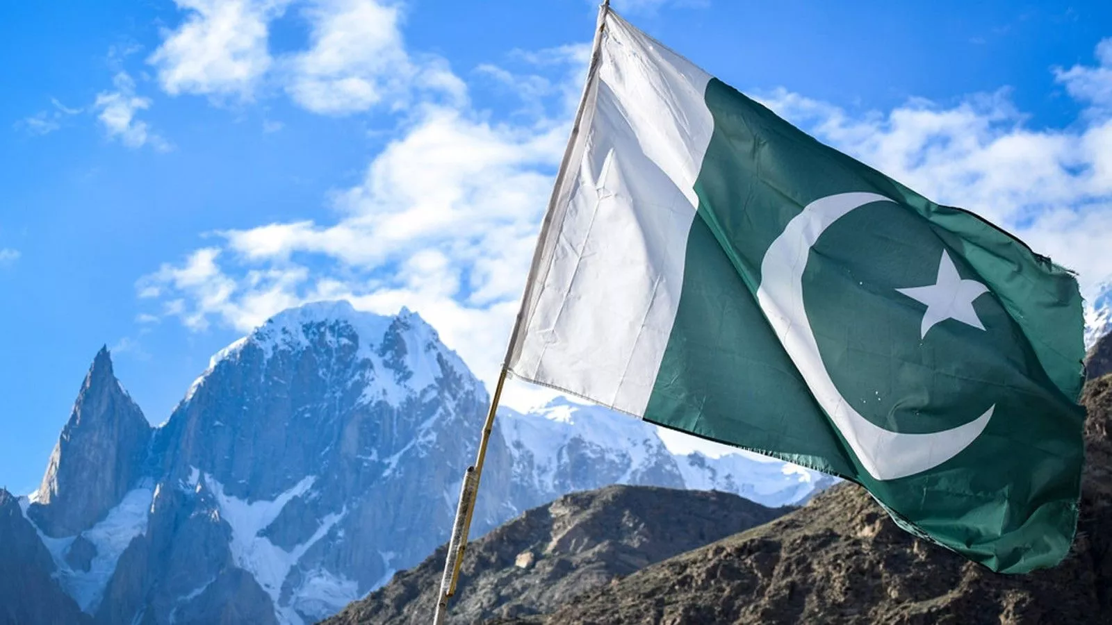 Pakistan Flag In White Covered Mountain