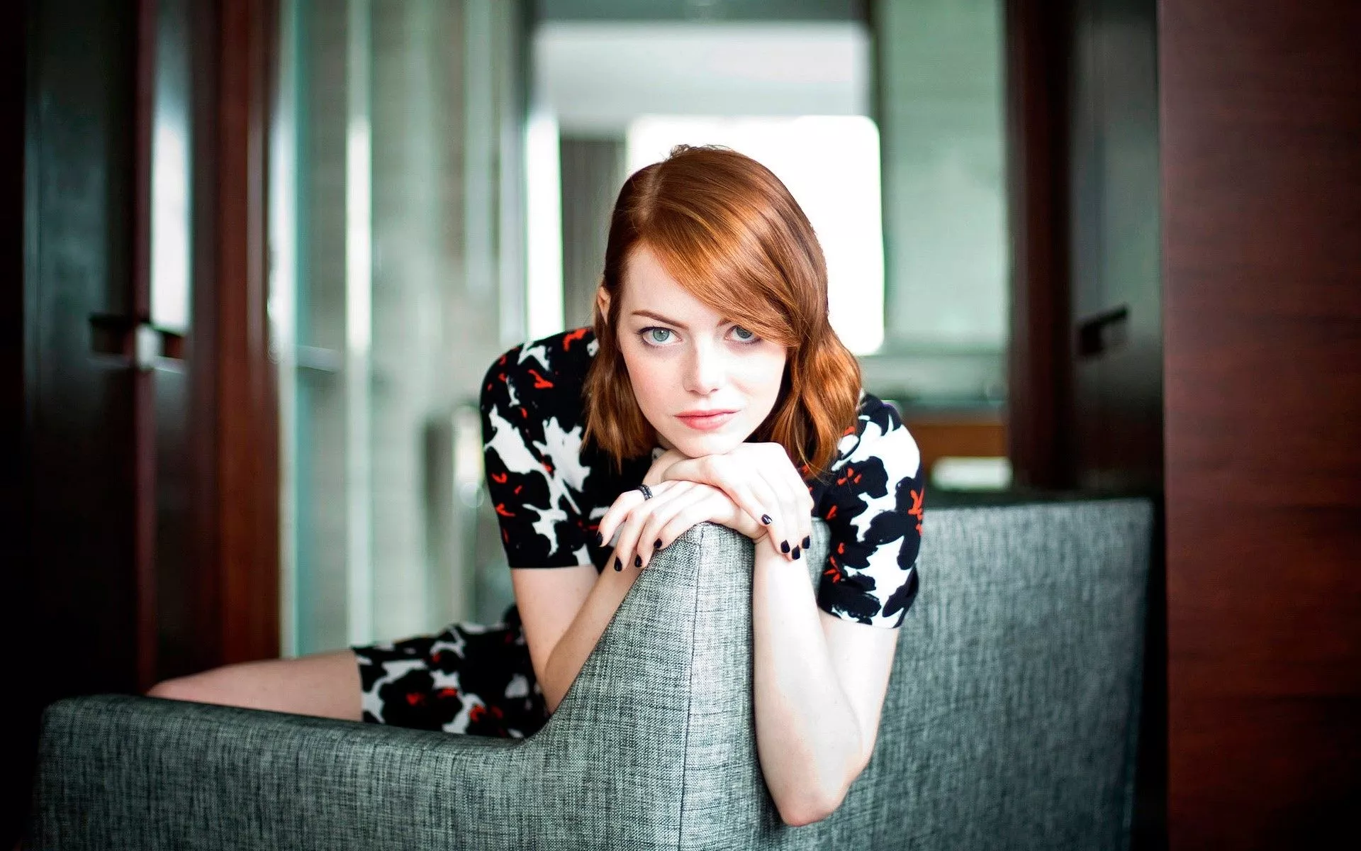 Emma Stone in an armchair Wallpaper