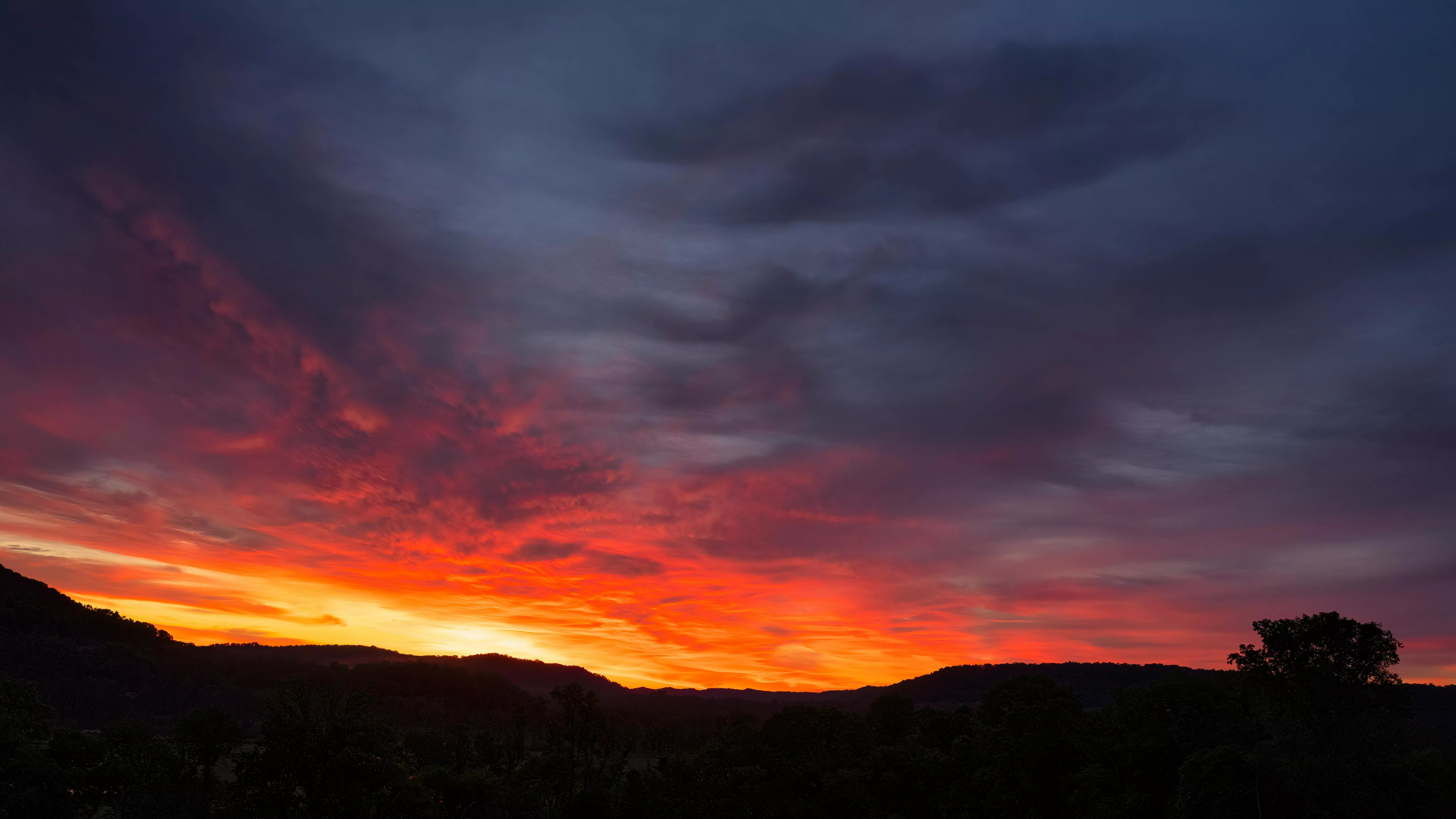 Red Sky at Sunset over Line on Hills