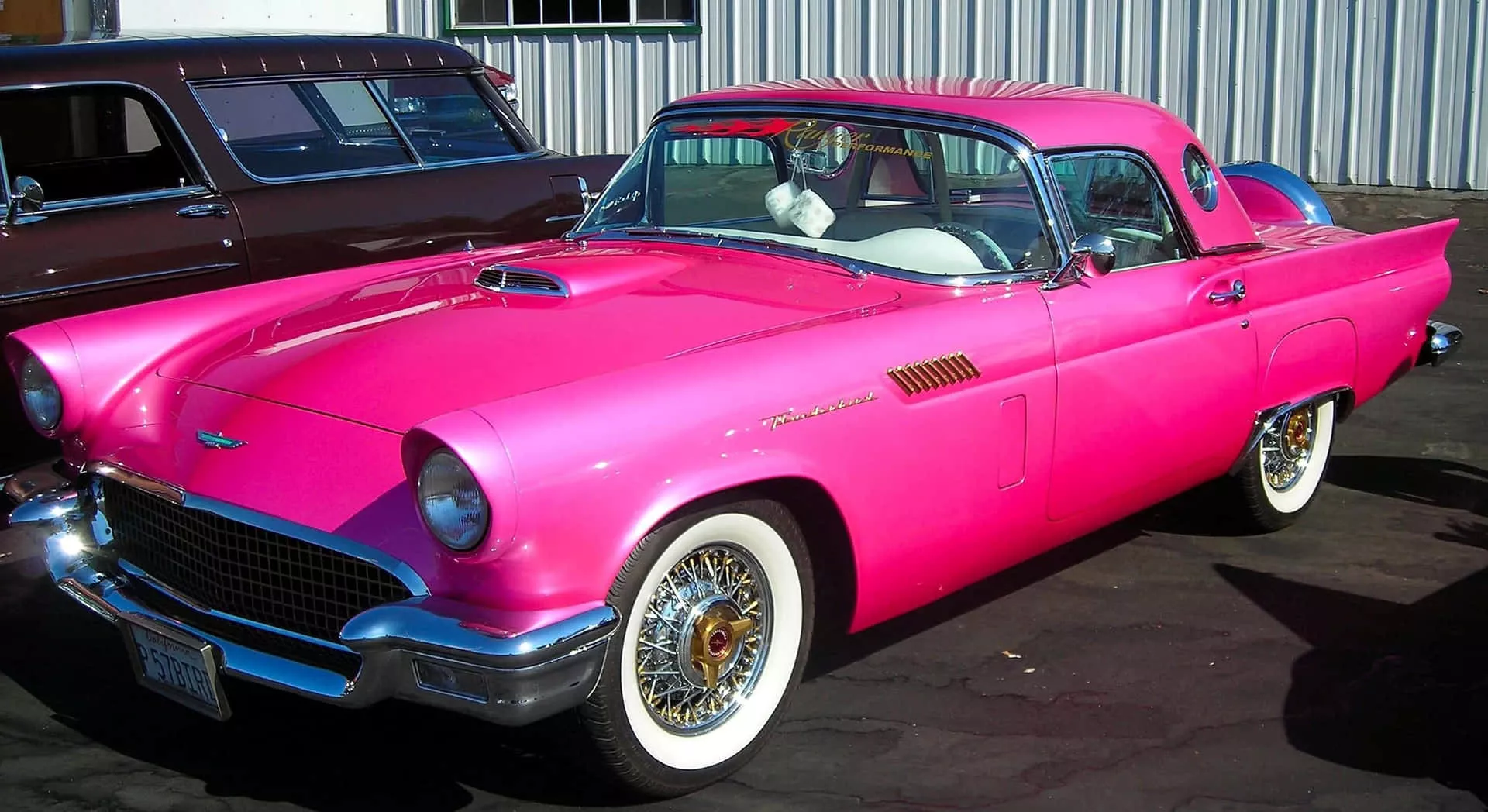 beautiful pink vintage car parked