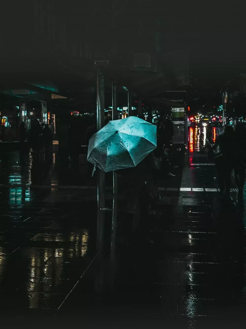 Rainy street at night with umbrella