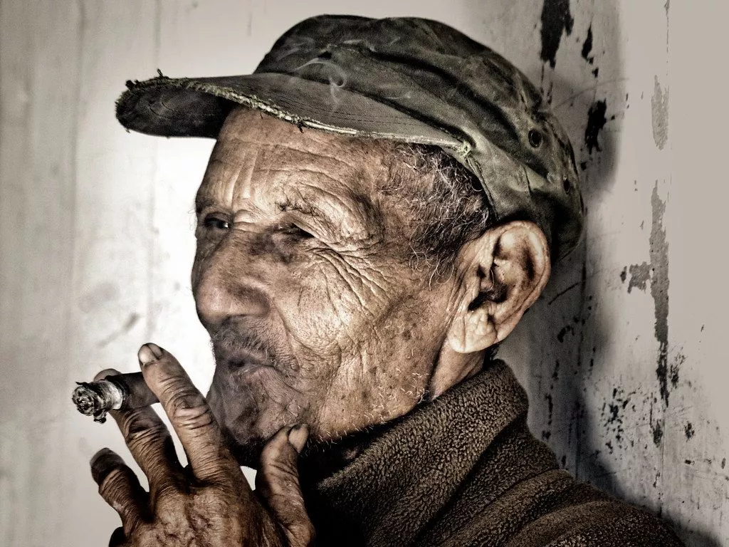 Old Man Smoking Cigar. Stop somewhere