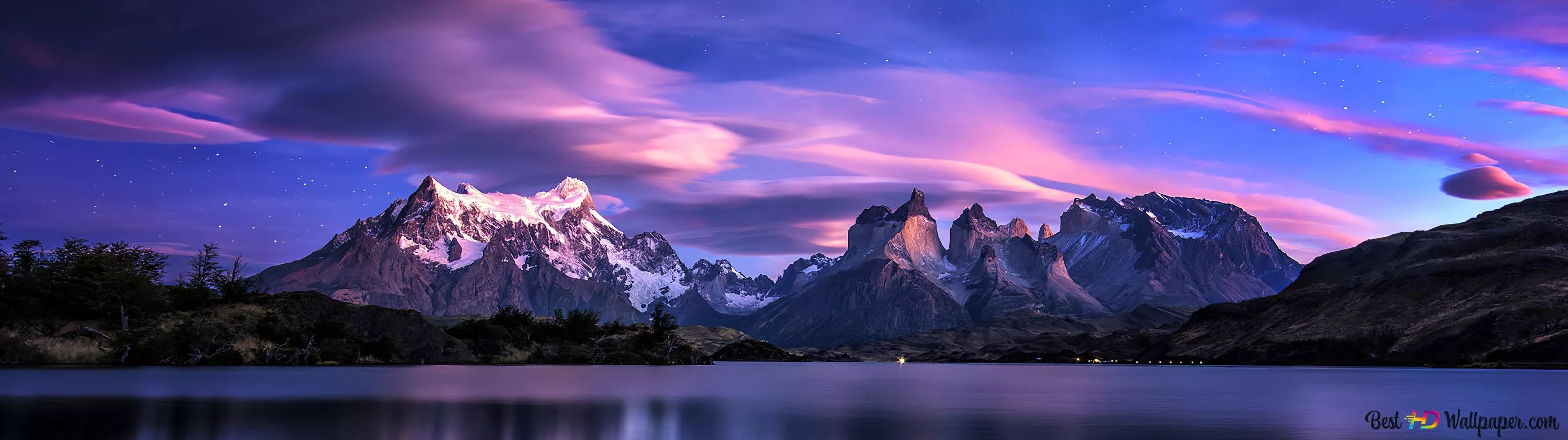 Snowy mountains and clouds reflected
