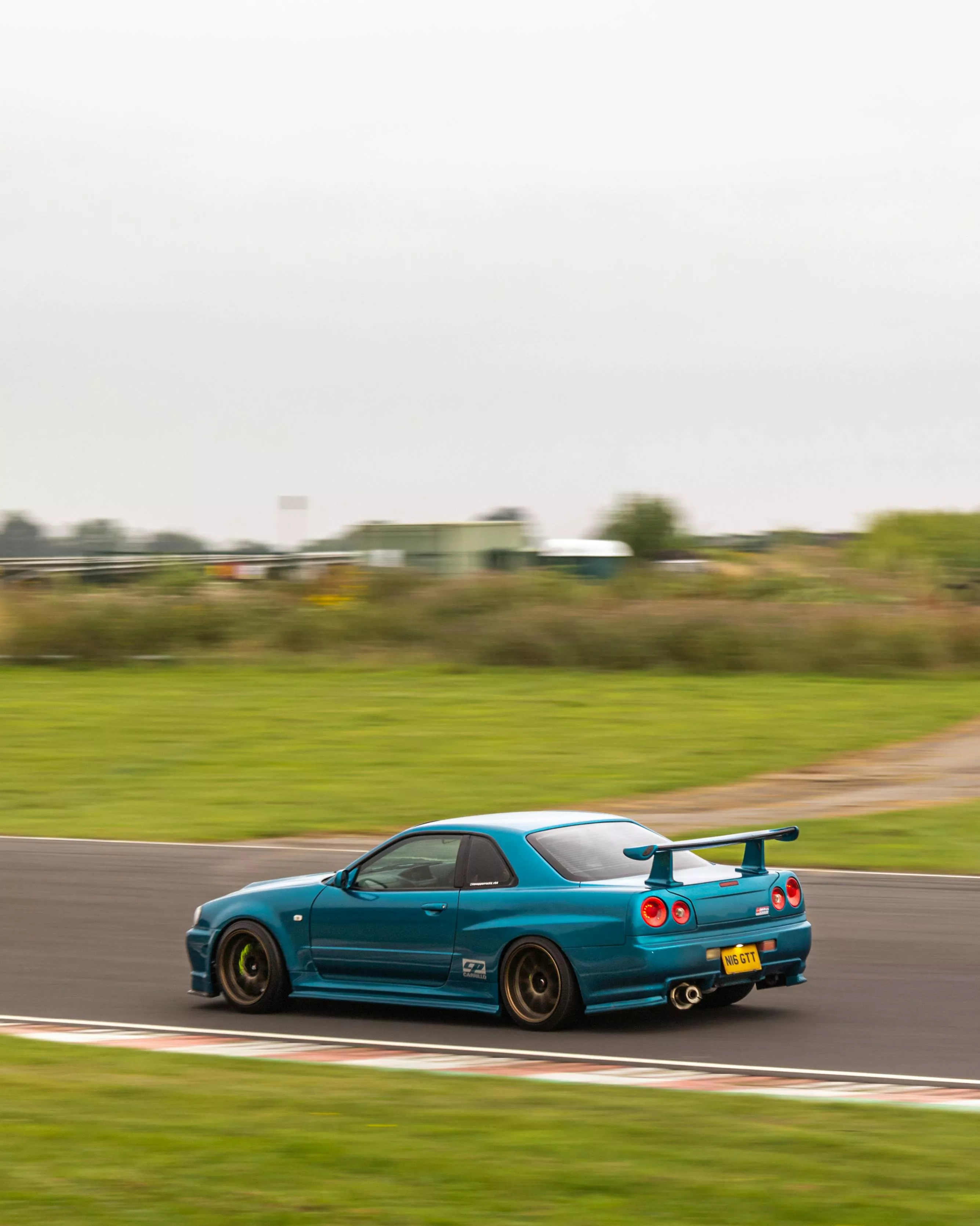 Photo of Blue Nissan Sports Car on Race