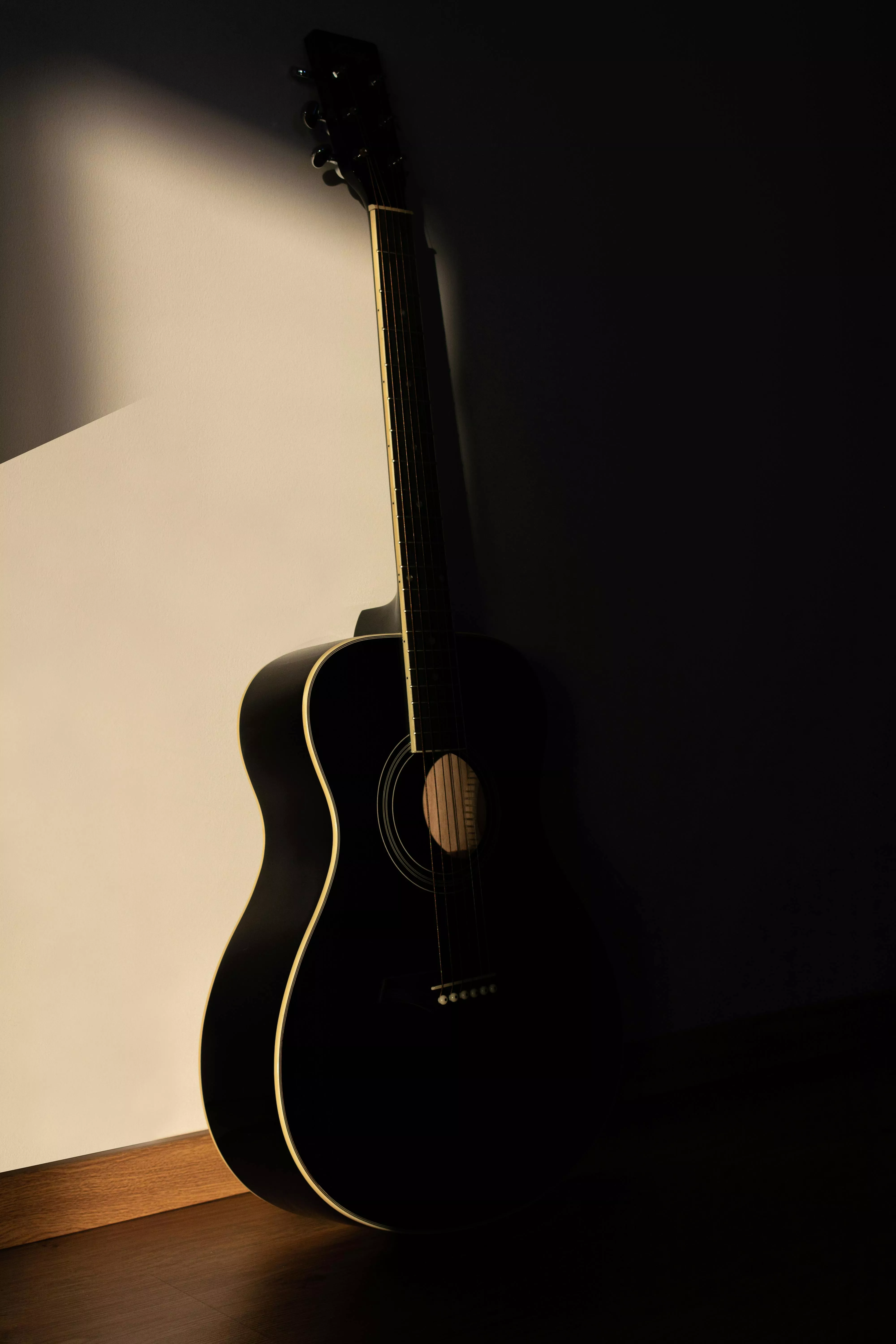 Black Acoustic Guitar Leaning on