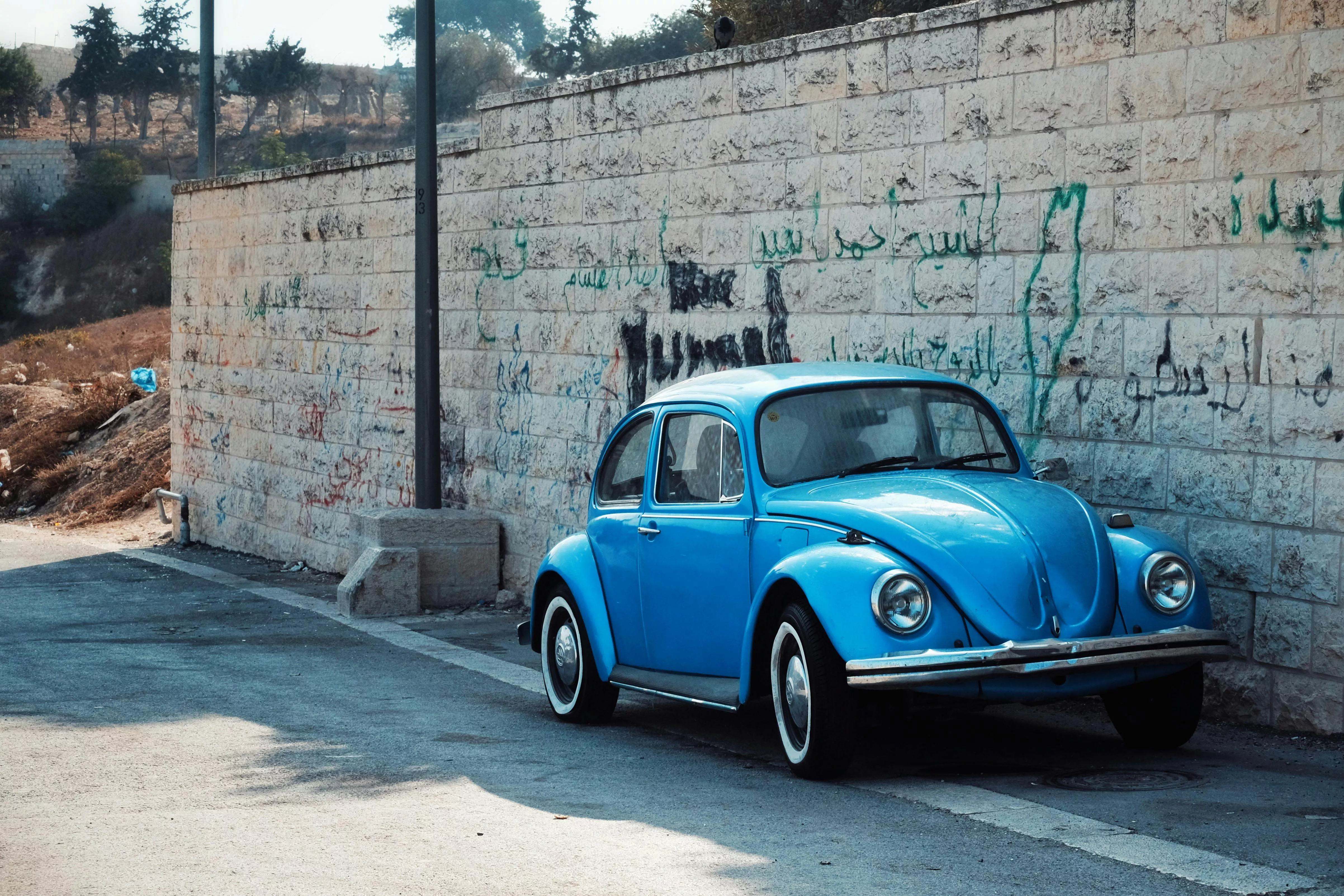 Blue Volkswagen Beetle near Wall · Free