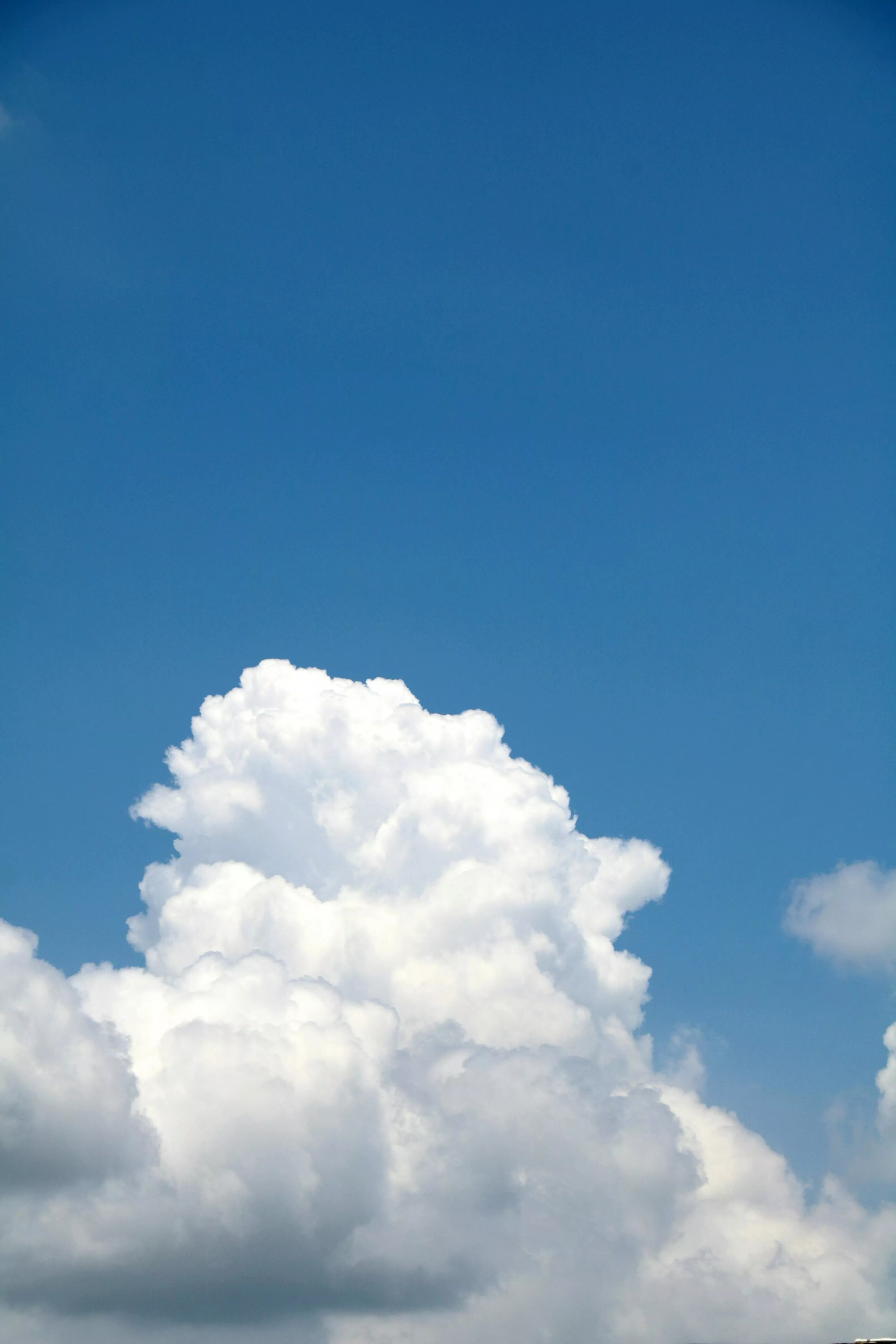 Fluffy clouds on bright blue sky · Free