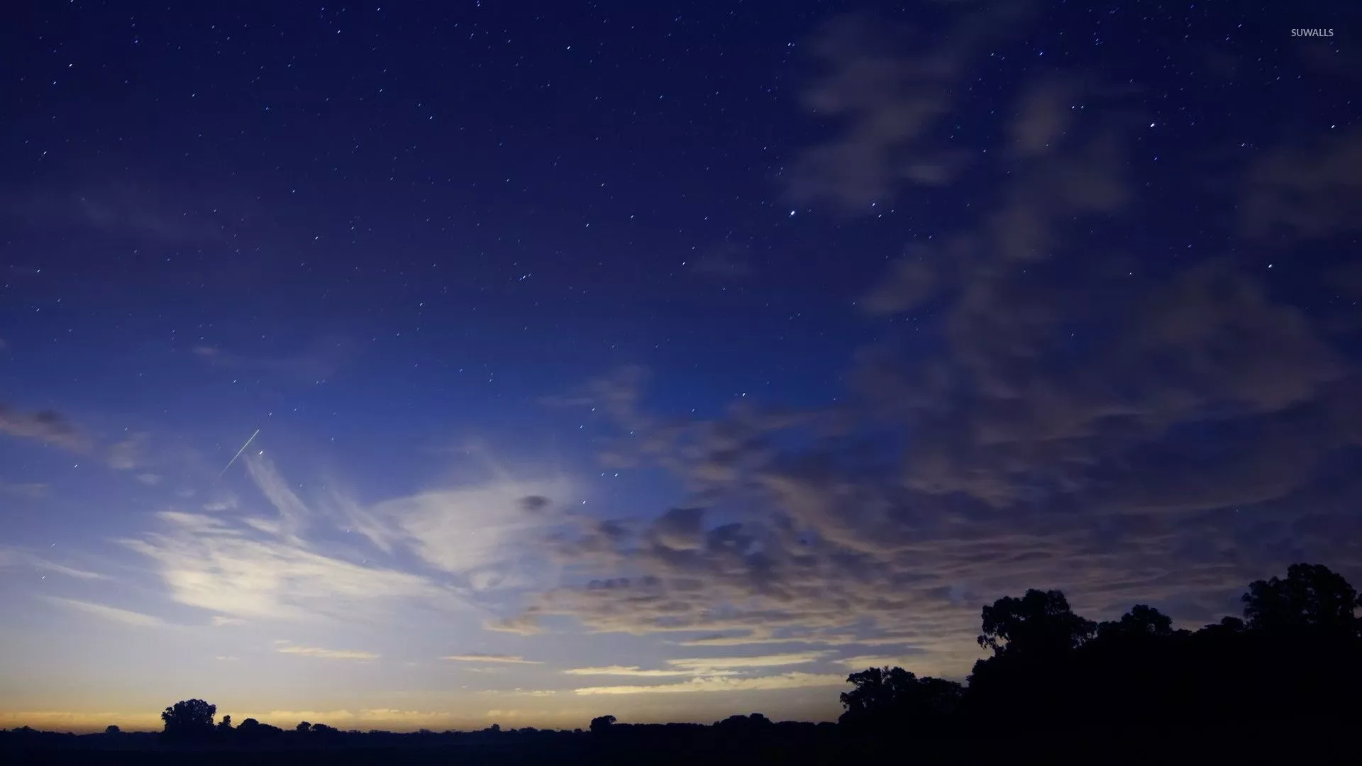 Fluffy clouds in the dark blue sky