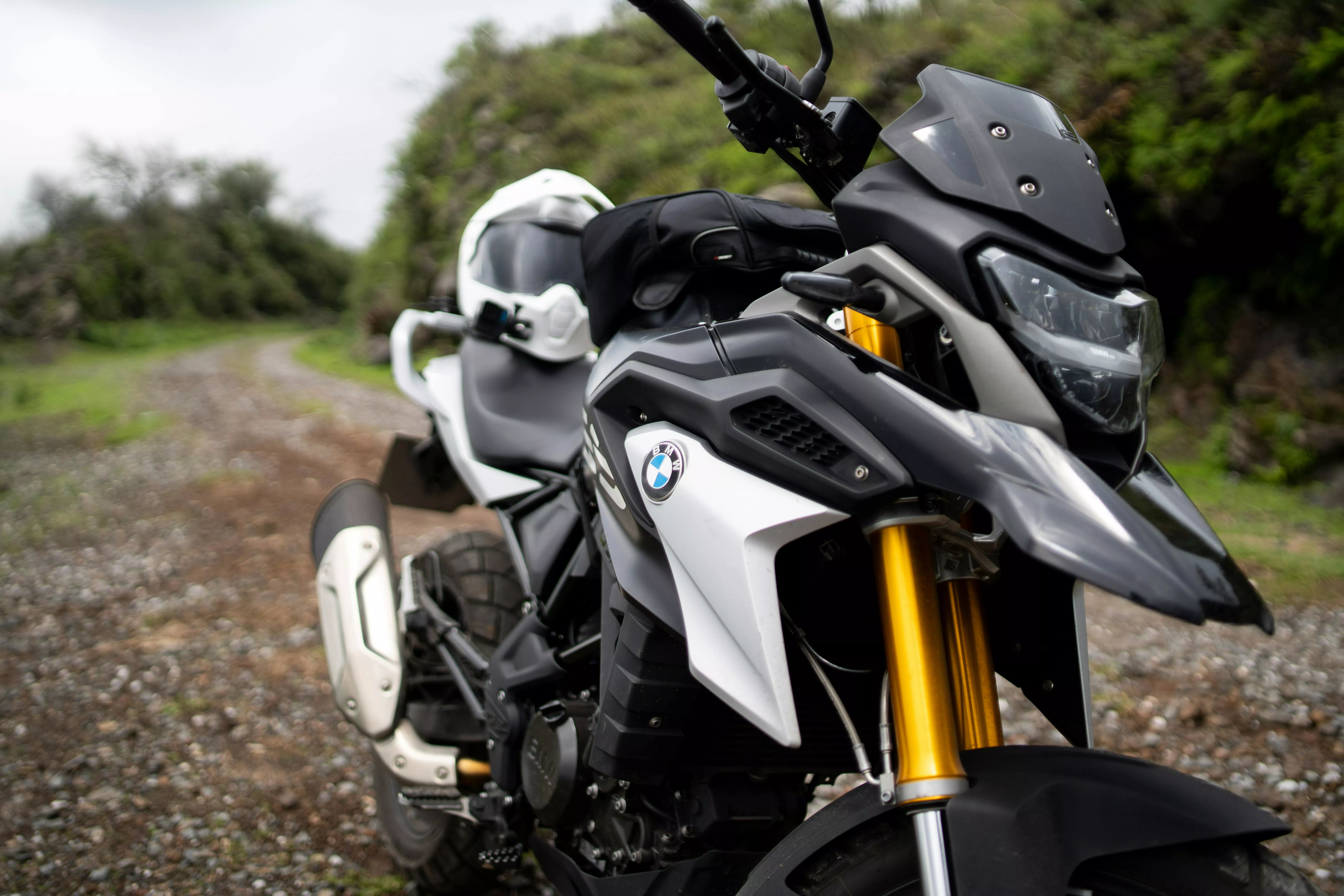A motorcycle parked on a gravel road