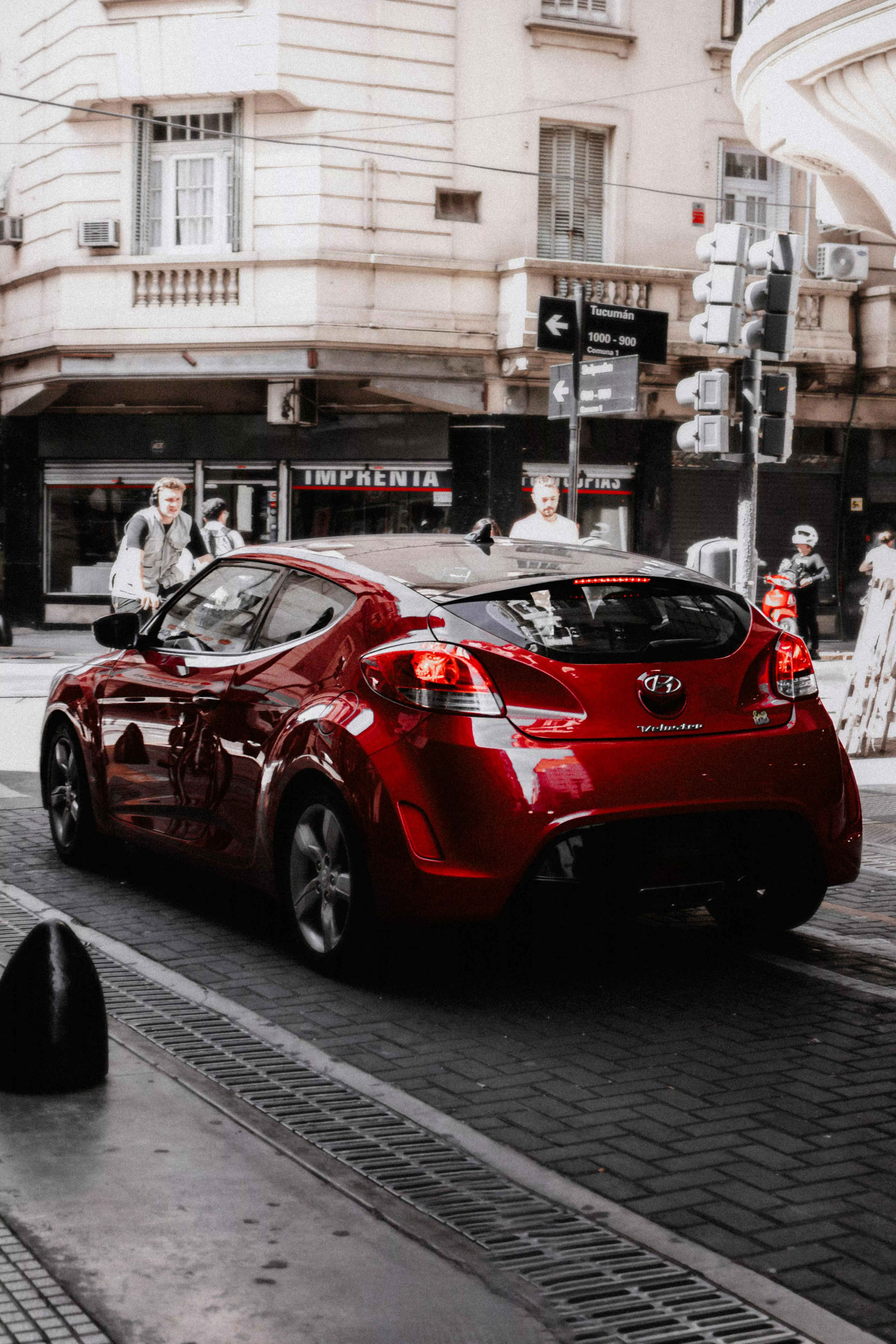 A Red 2013 Hyundai Veloster on a Street