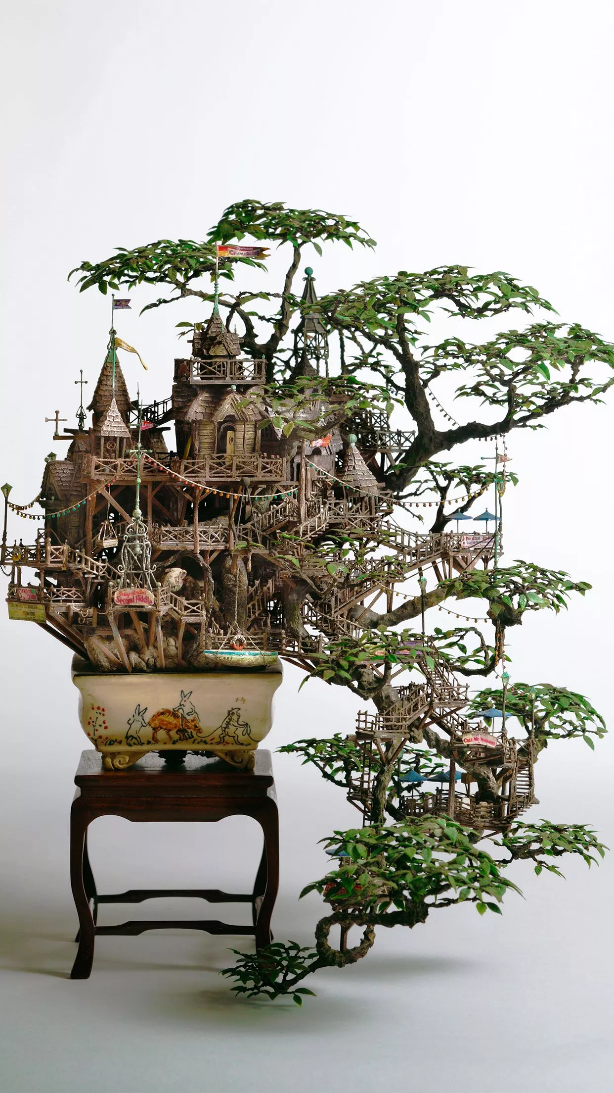 A metallic bonsai tree in a zen garden