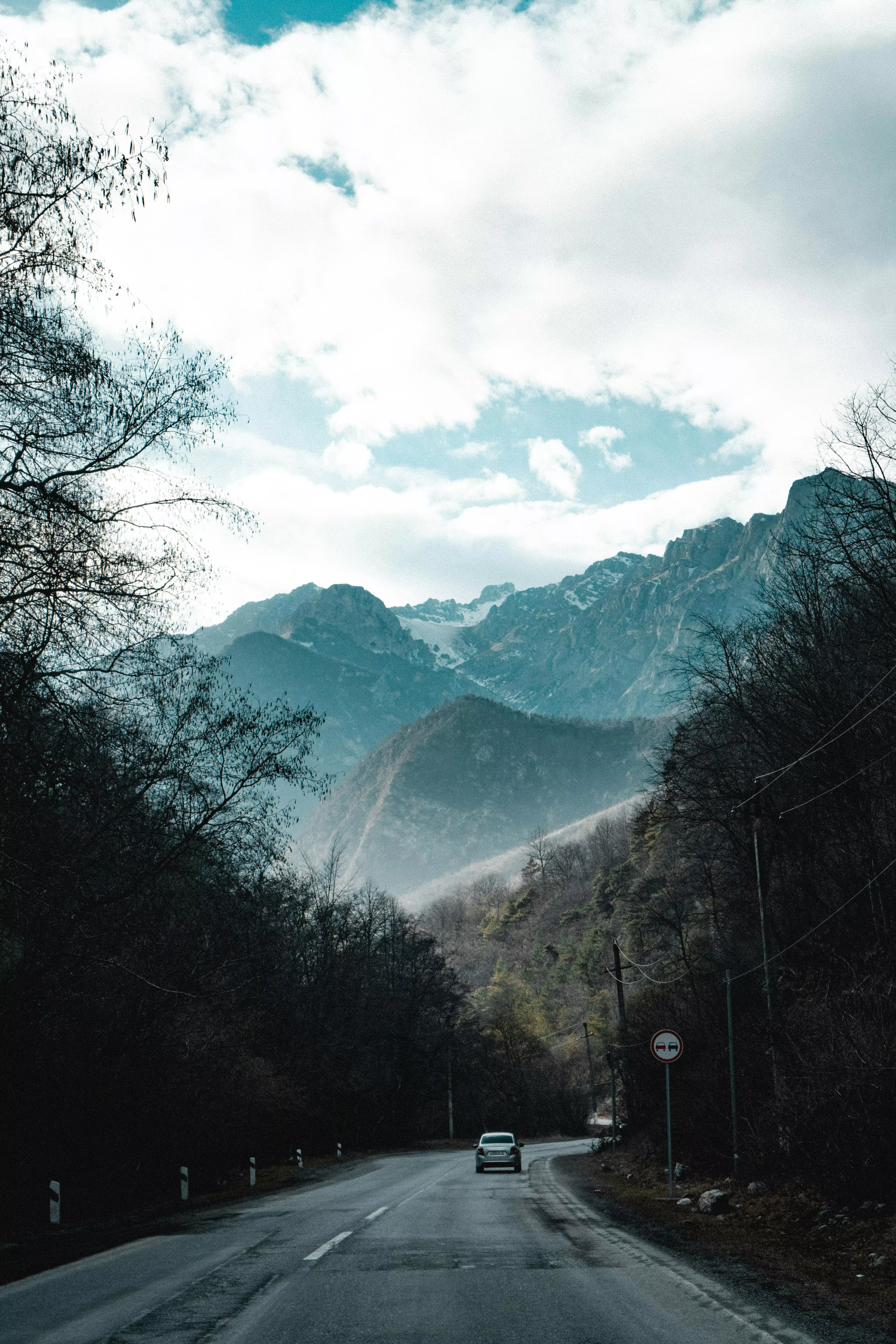 A Car Passing Through a Mountain Road
