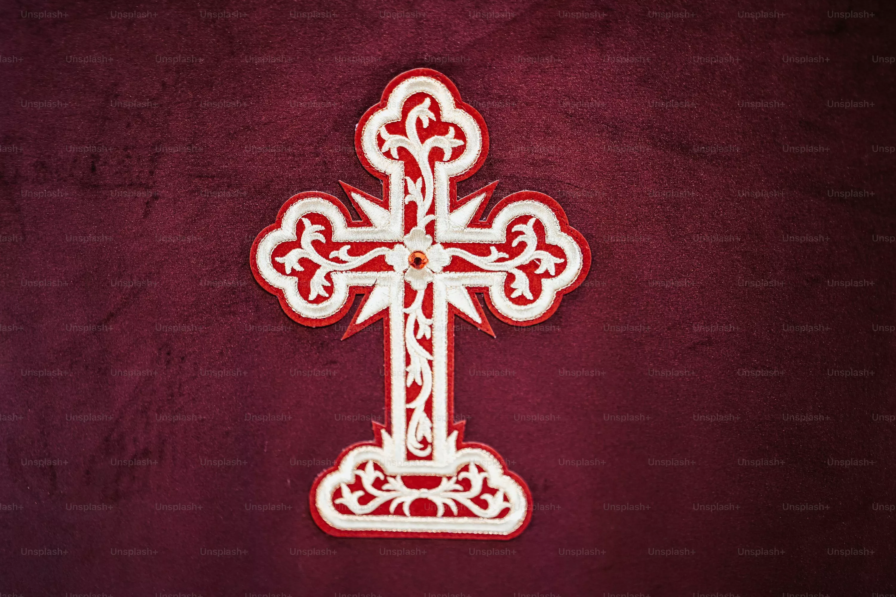 A wooden cross with a statue of jesus