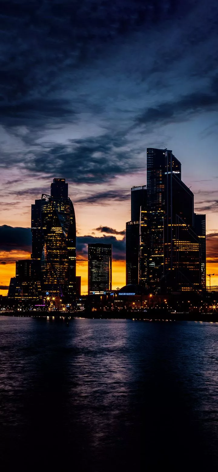 Dark City Buildings In Front Of A Lake