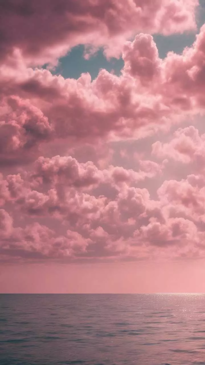 An array of fluffy pink clouds casting