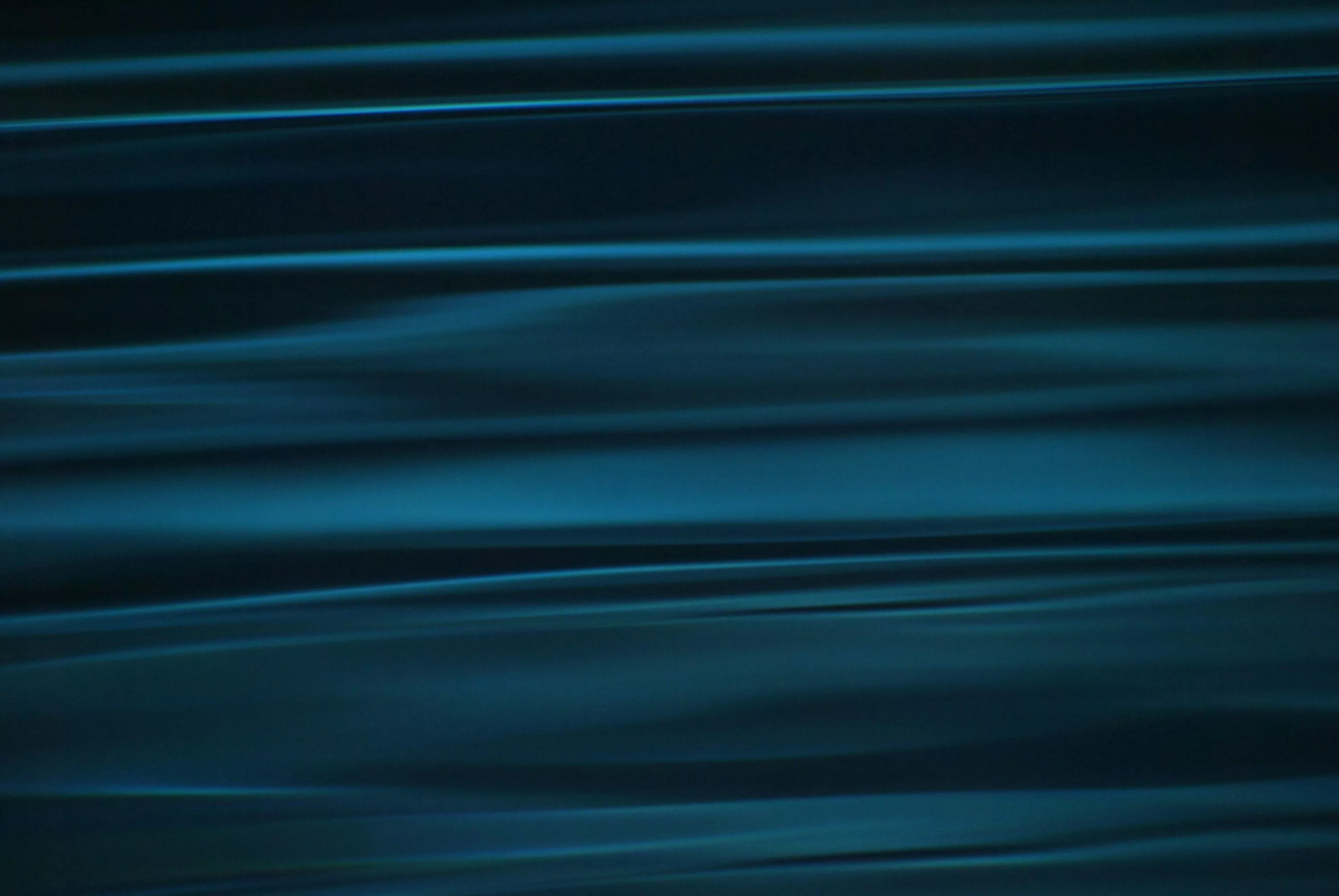 A blurry photo of water with a blue hue