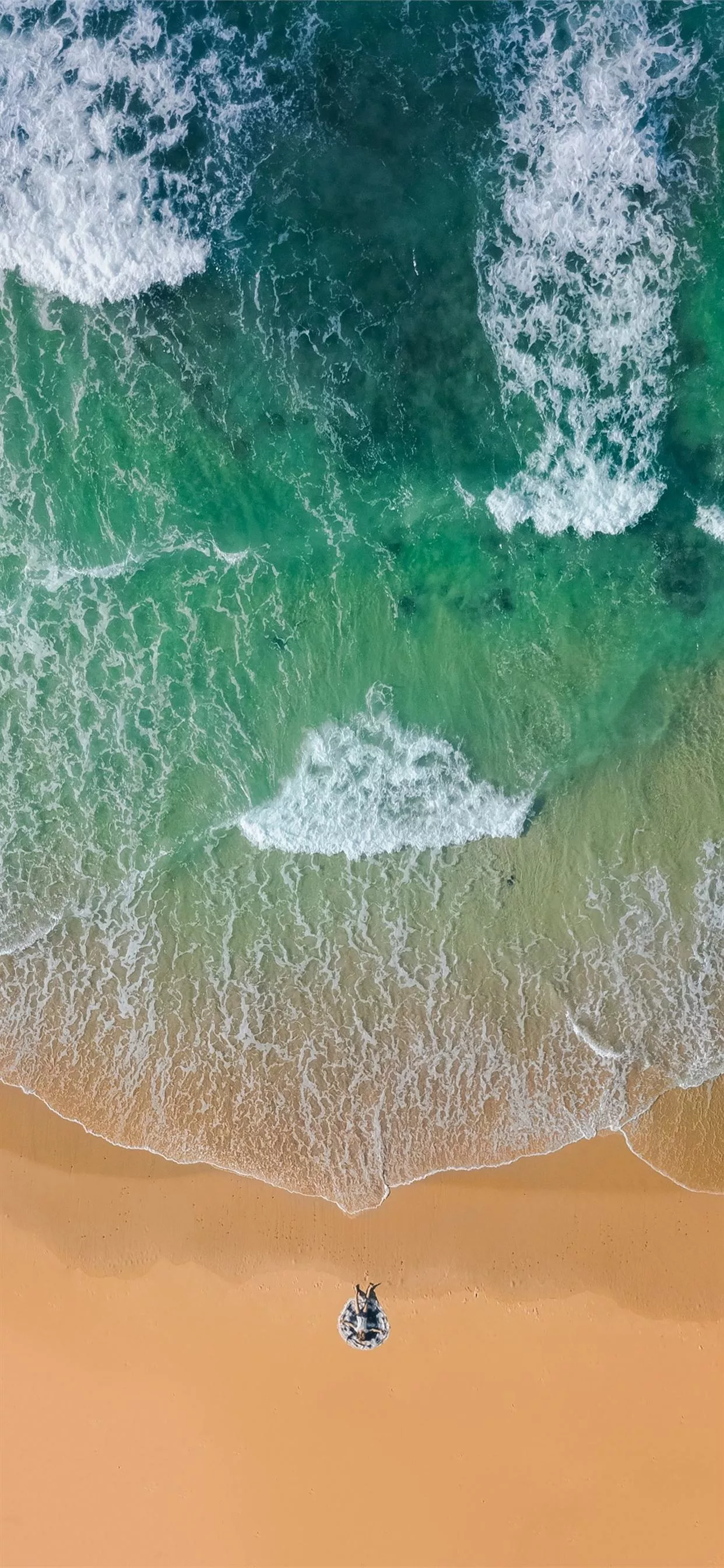 brown sand on beach with t. iPhone 11