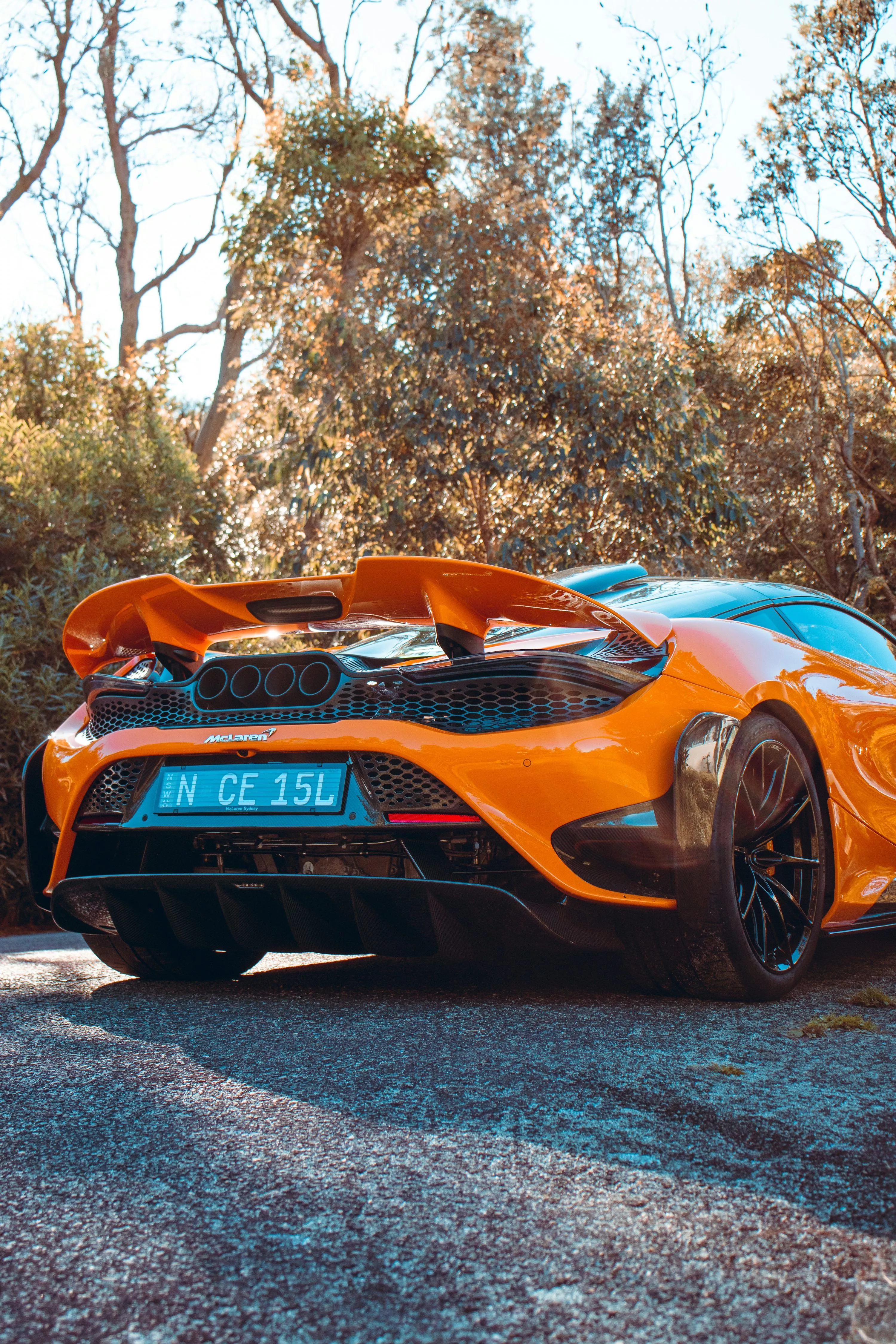 An orange sports car parked on the side
