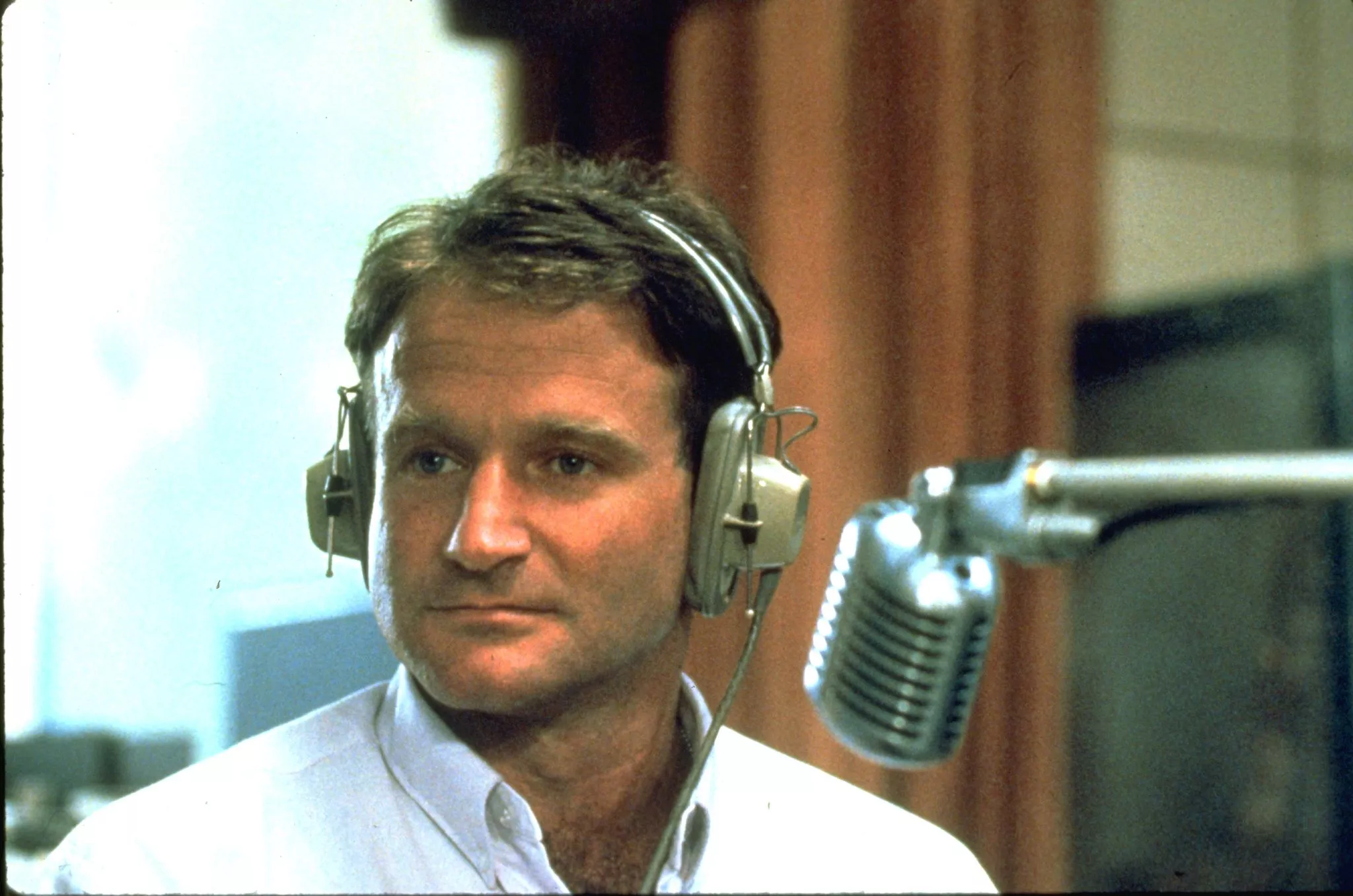 Robin Williams as Adrian Cronauer