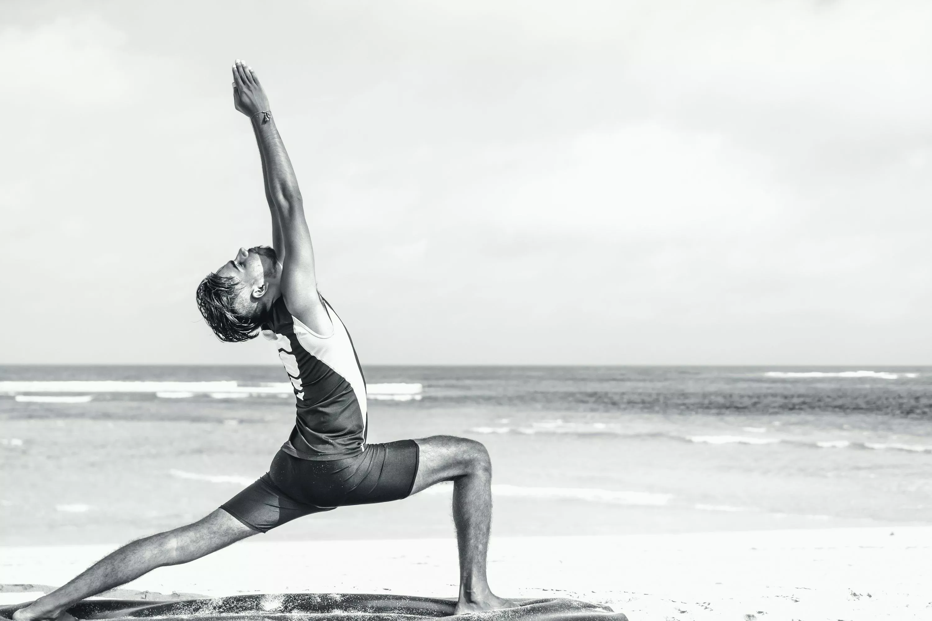 Man stretching on seashore photo
