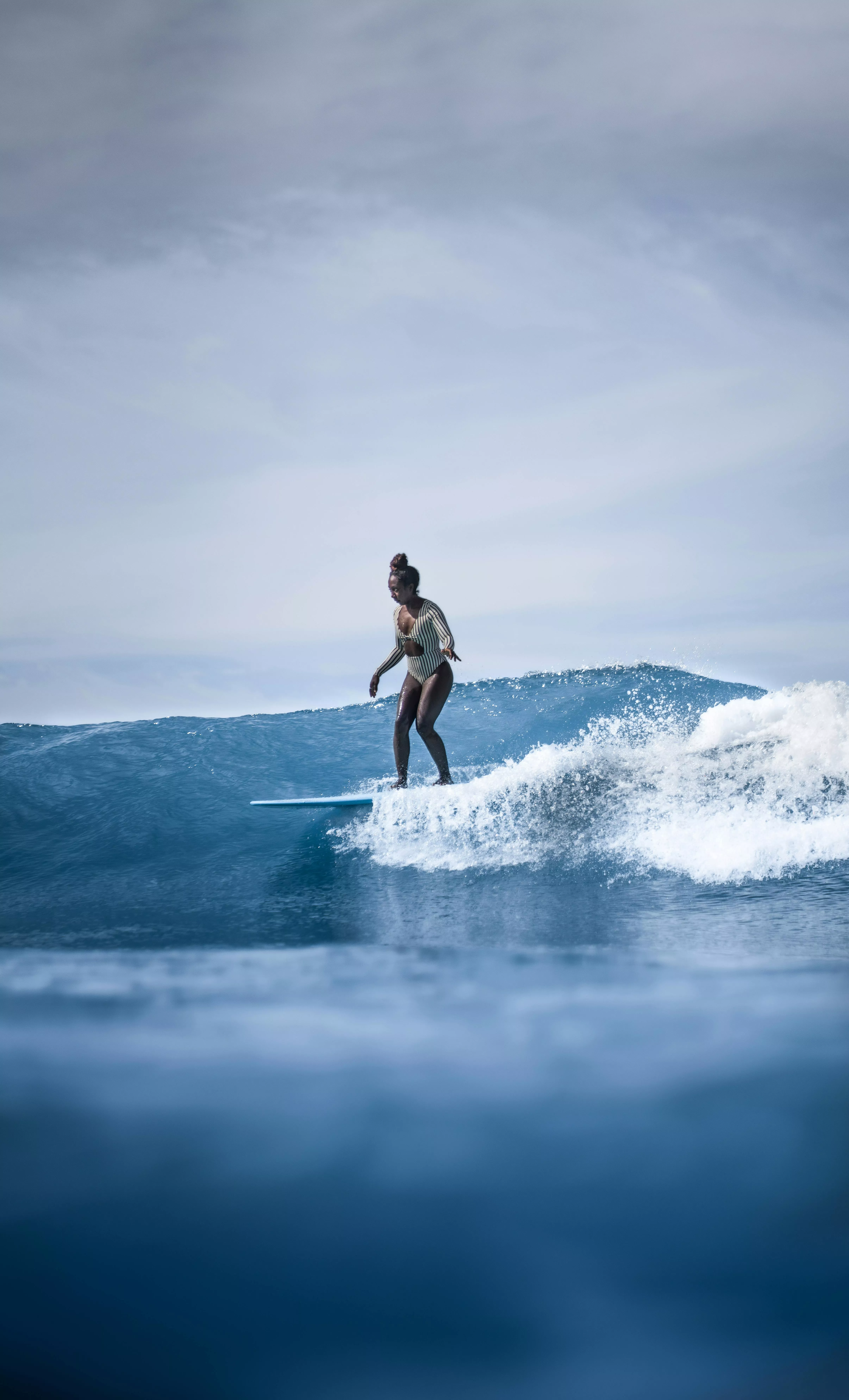 female surfer riding surfboard