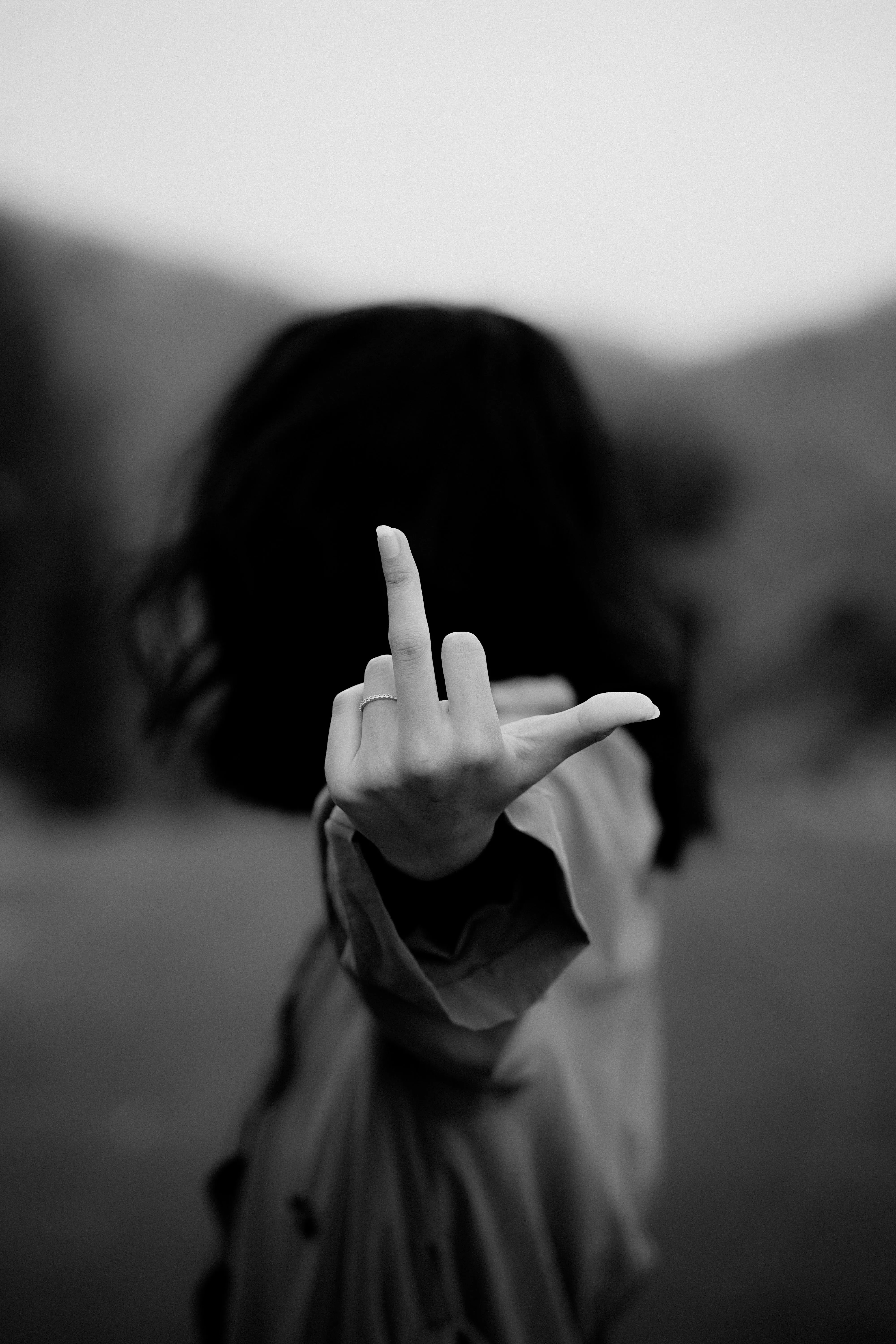 Grayscale Photo of Woman Raising Her