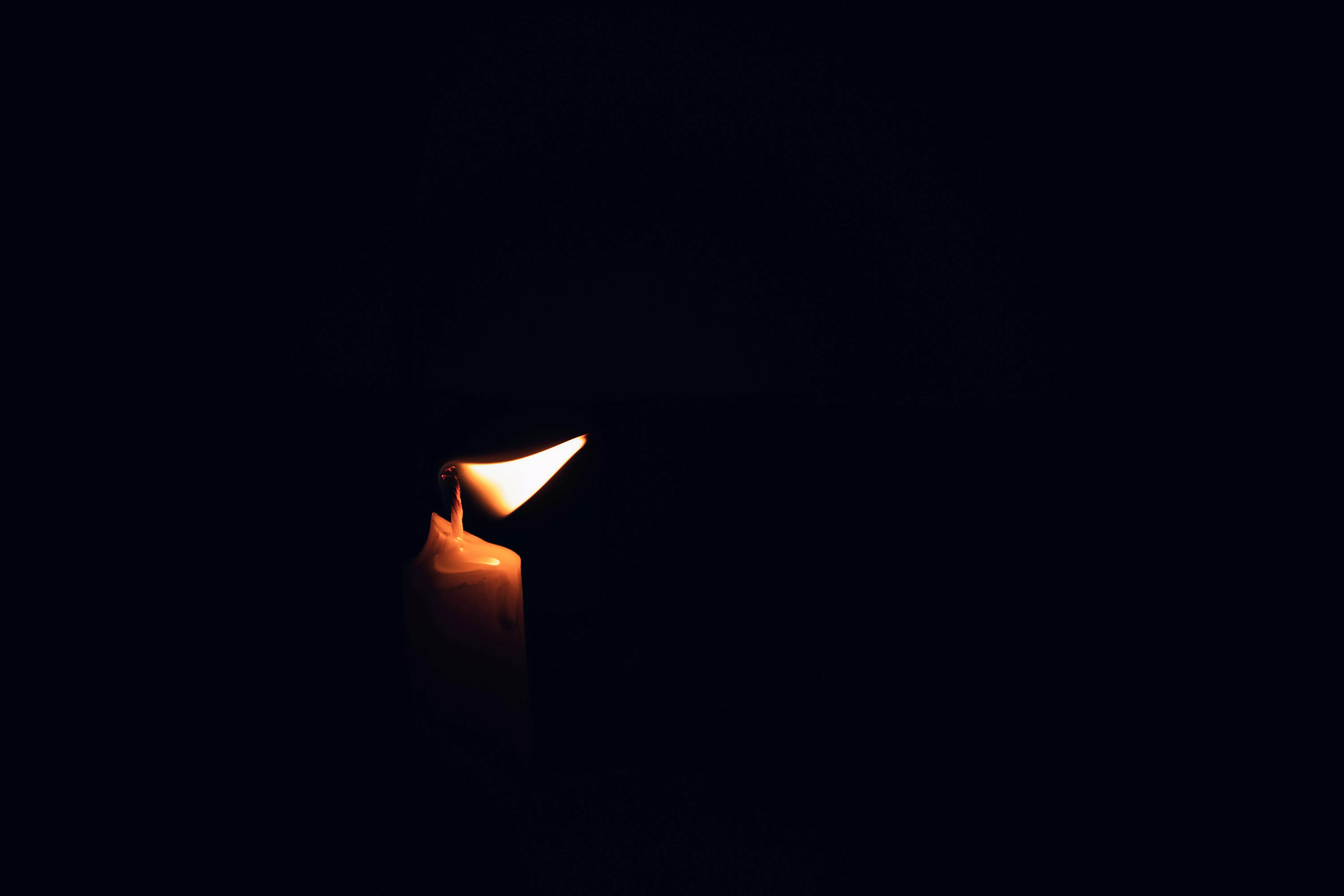 Lighted Candle on a Black Background