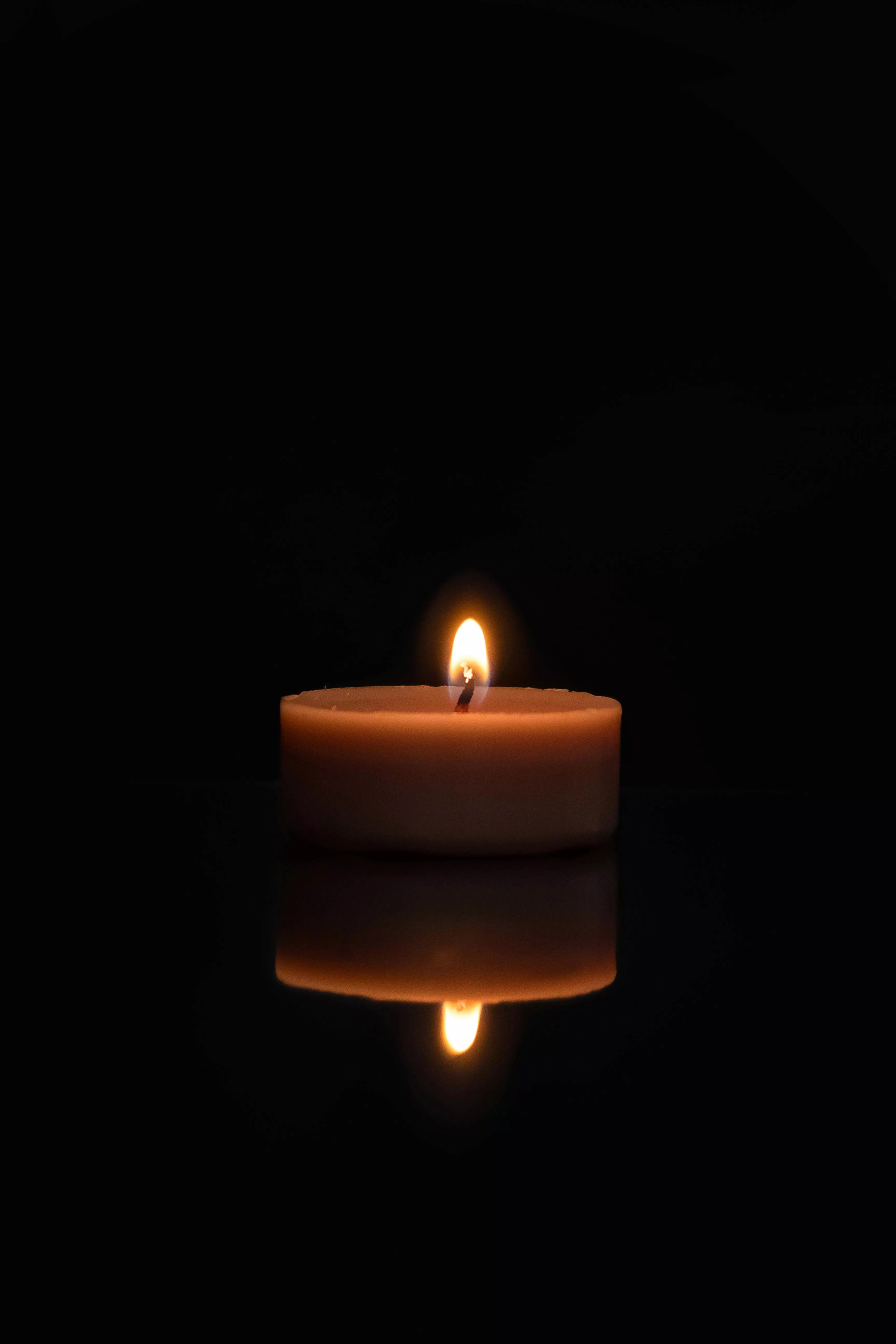 Burning Candle in Dark Background
