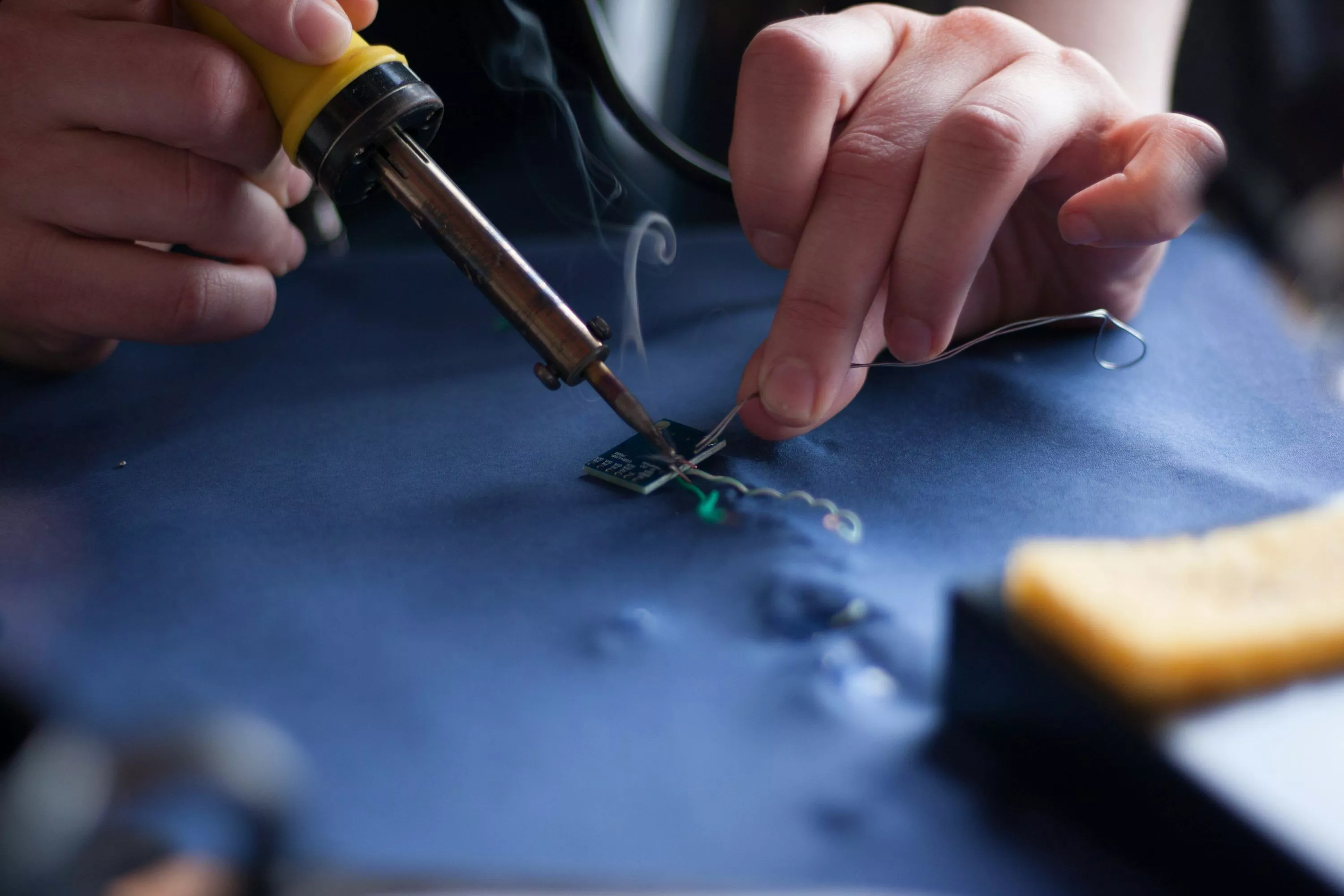 Person using soldering iron photo