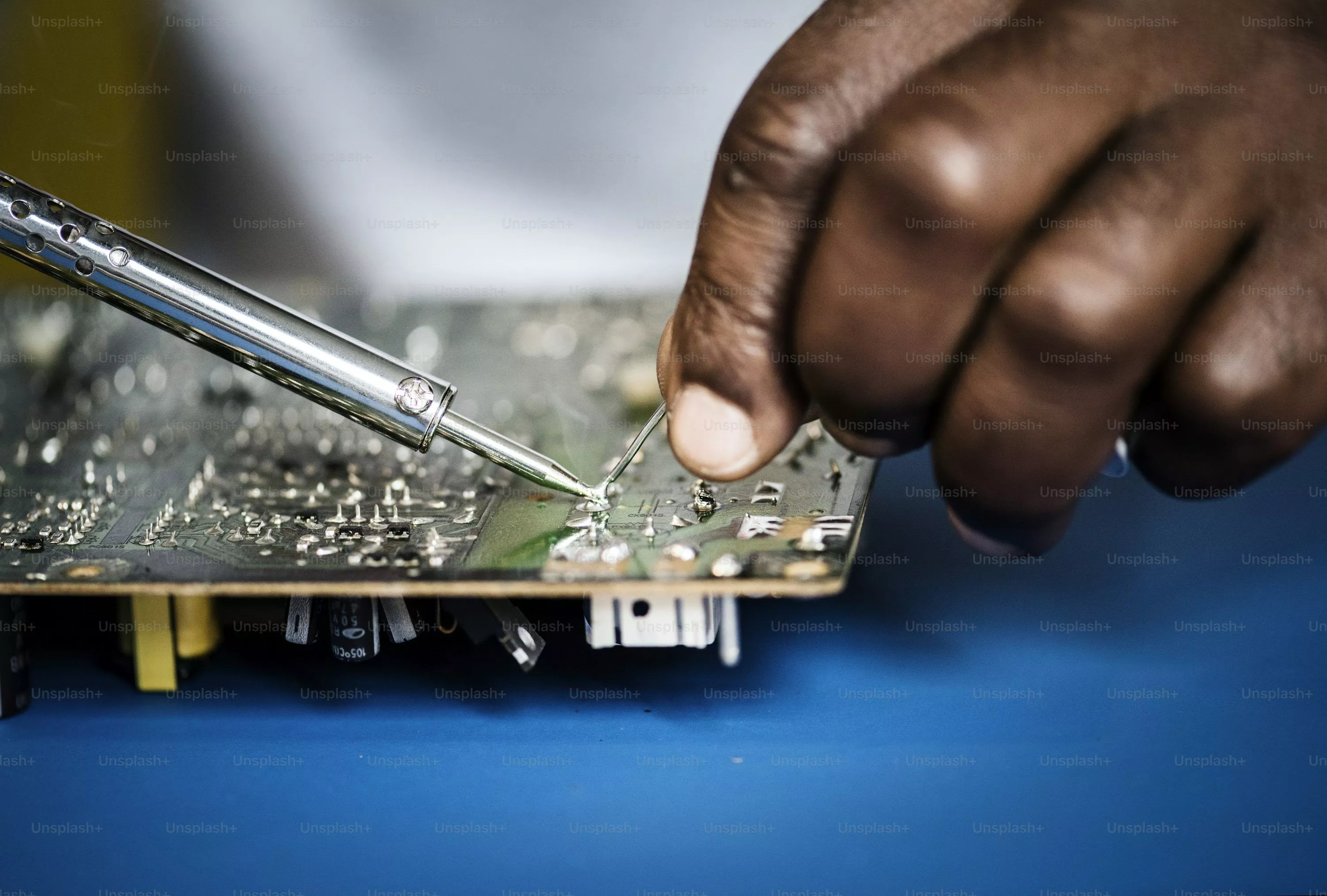 Hands of young repairperson fixing tiny