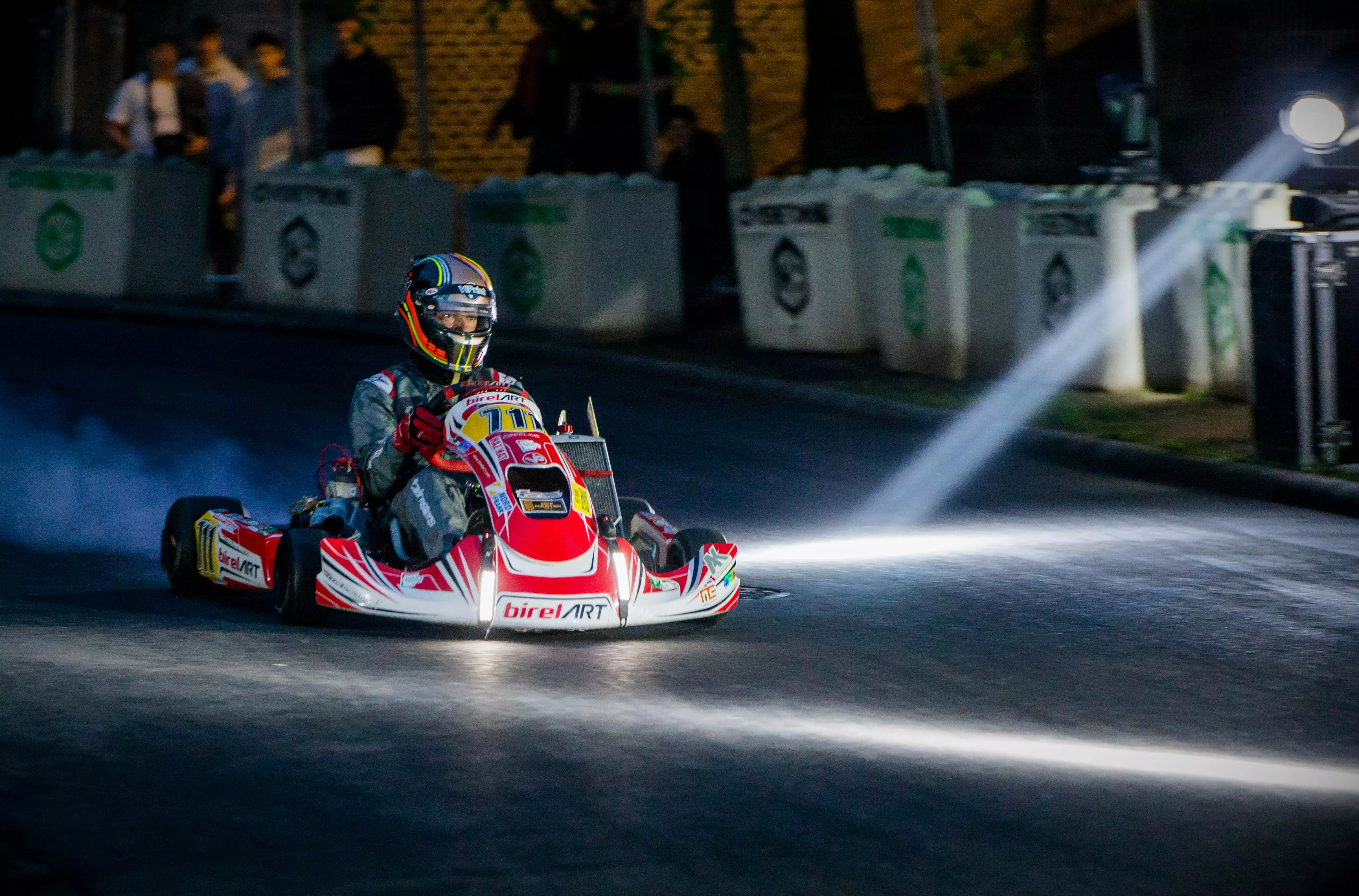 People Driving Go Karts In Racetrack