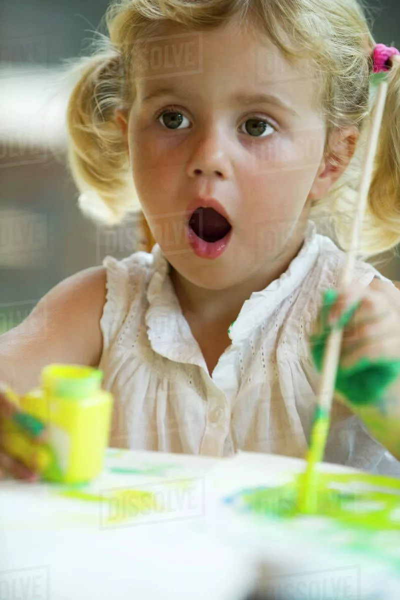 girl painting with surprised expression