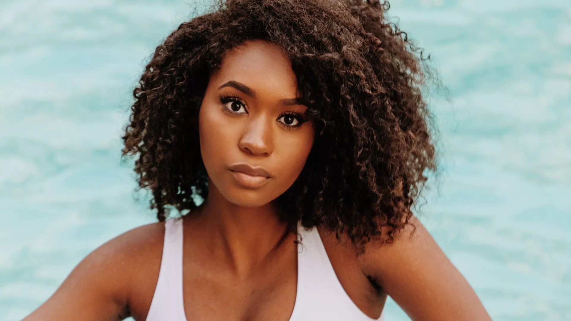 Curly Hair Black Girl In Sea Background