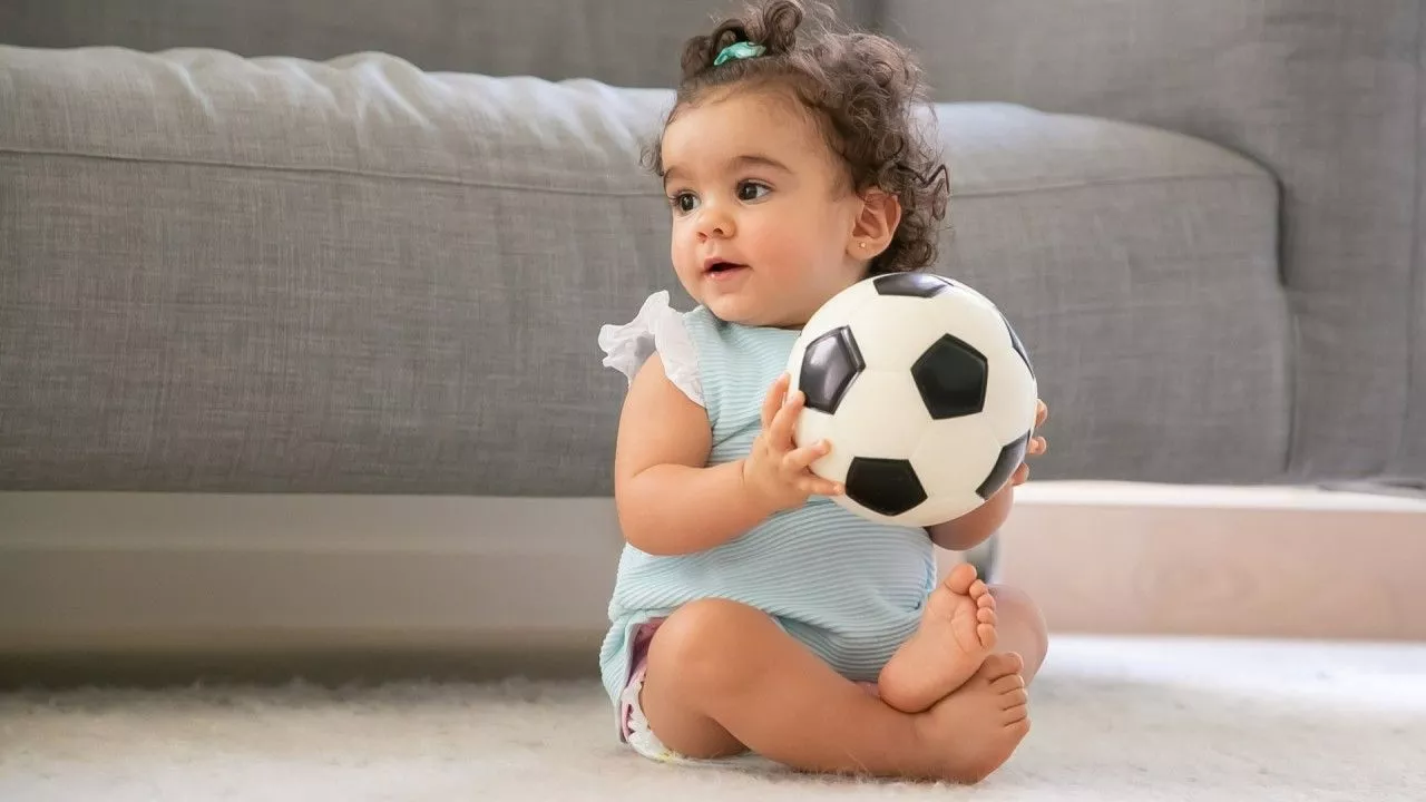 Cute Baby Girl With Ball Wearing Light