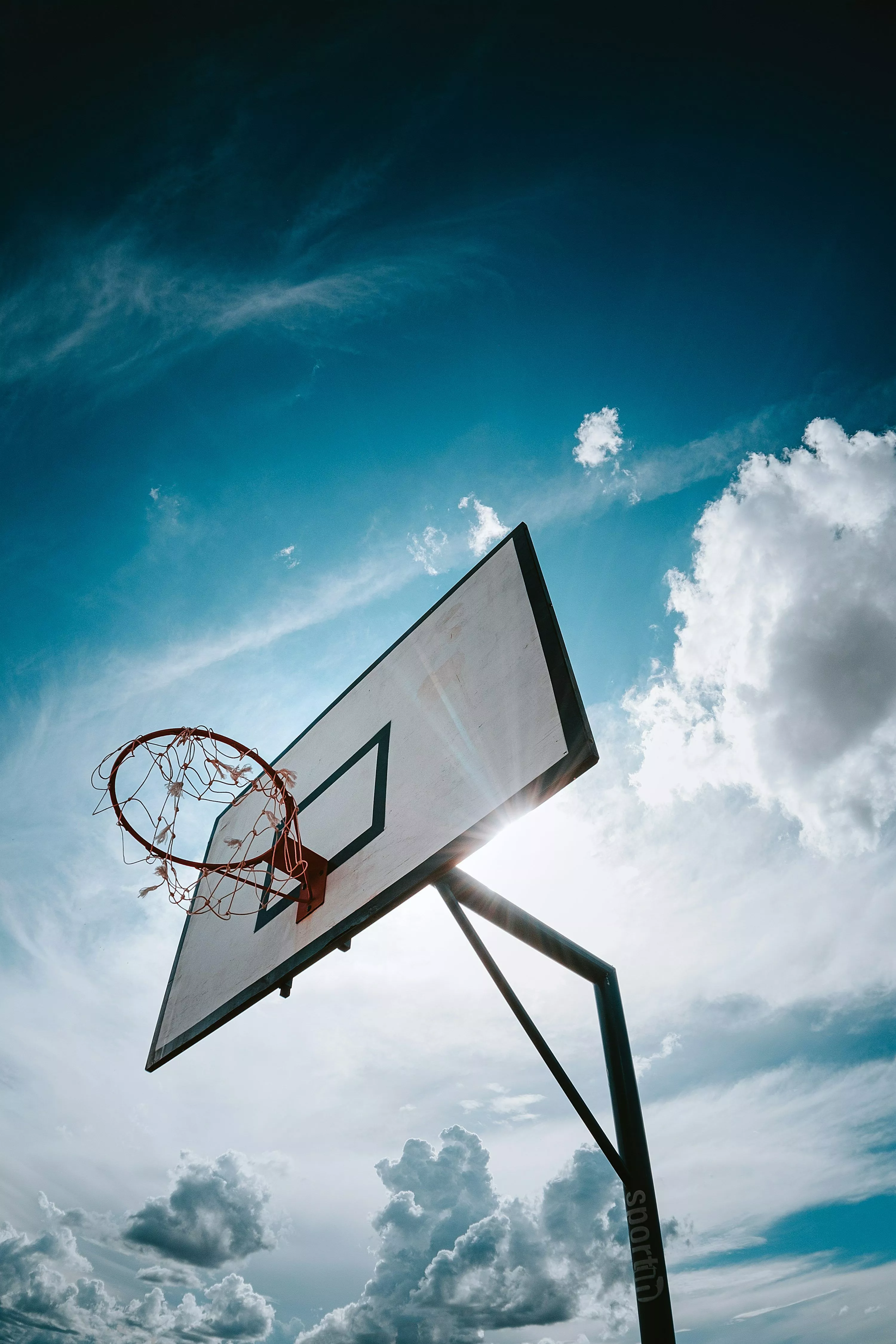 Basketball hoop under blue sky during