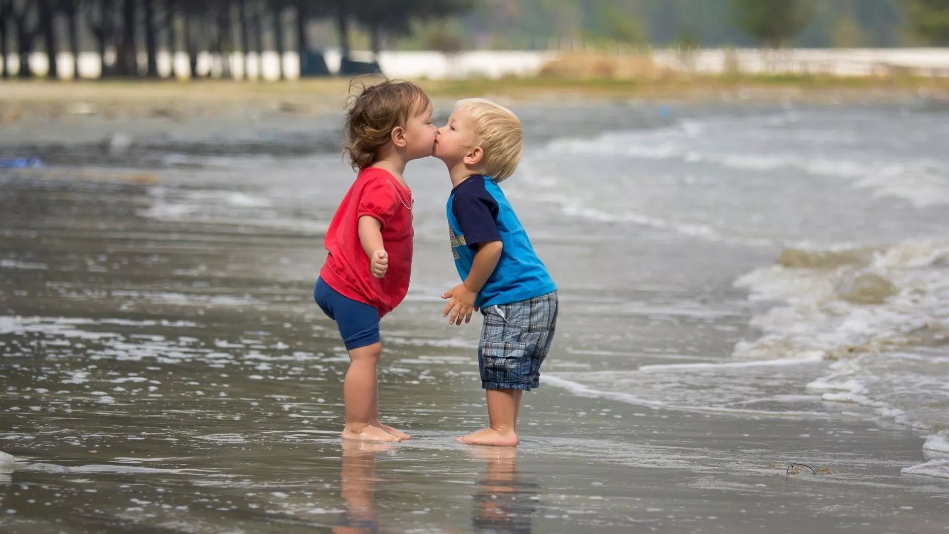 Cute Kids Are Standing On Beach Water
