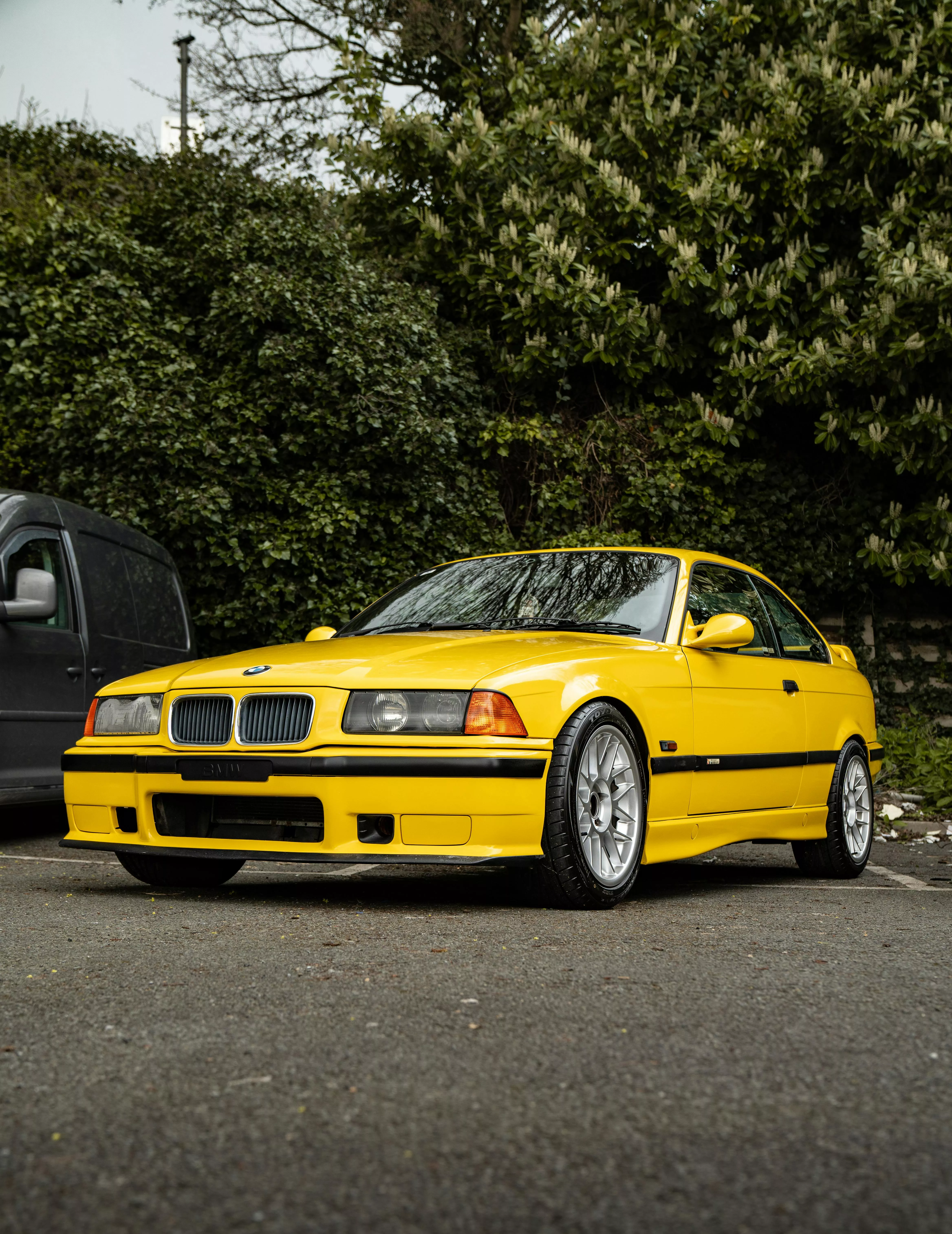 A Yellow BMW E36 in the Parking Lot