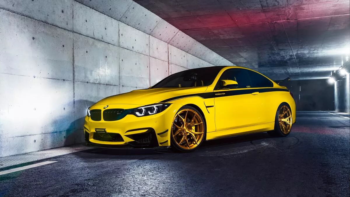Yellow bmw m4 with a black stripe