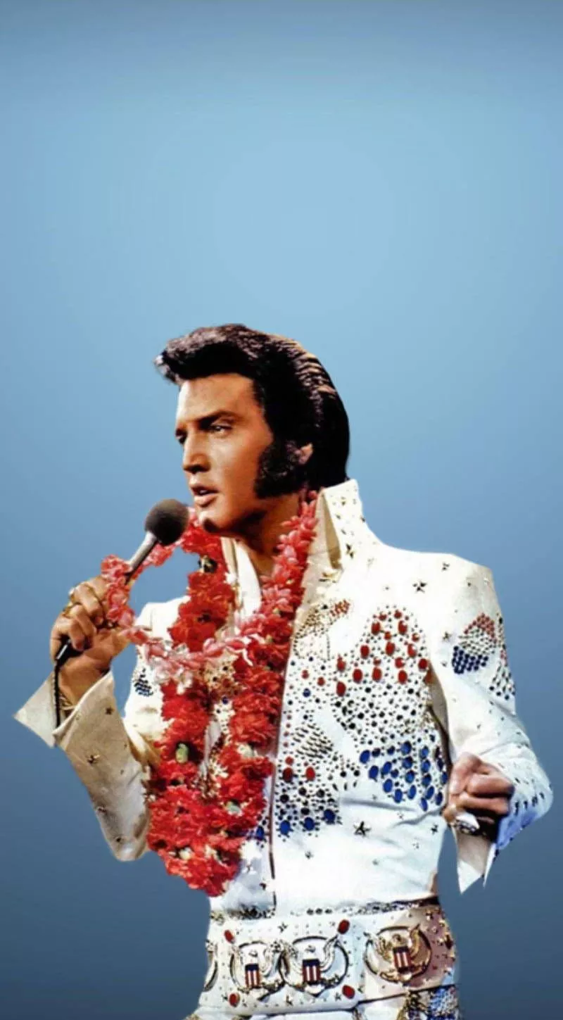 Iconic Image Of Elvis Presley Against A
