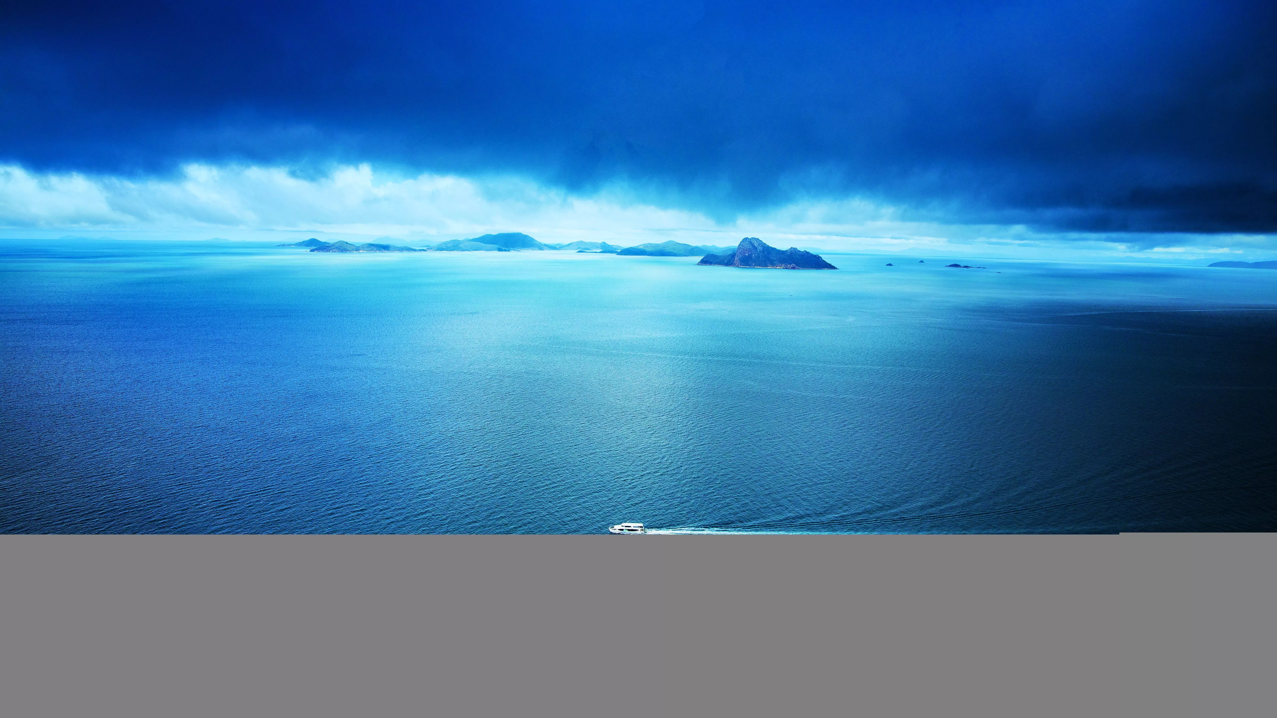 Blue Ocean Between White Ship Background Of Mountains 4K 5K HD Nature Wallpaper