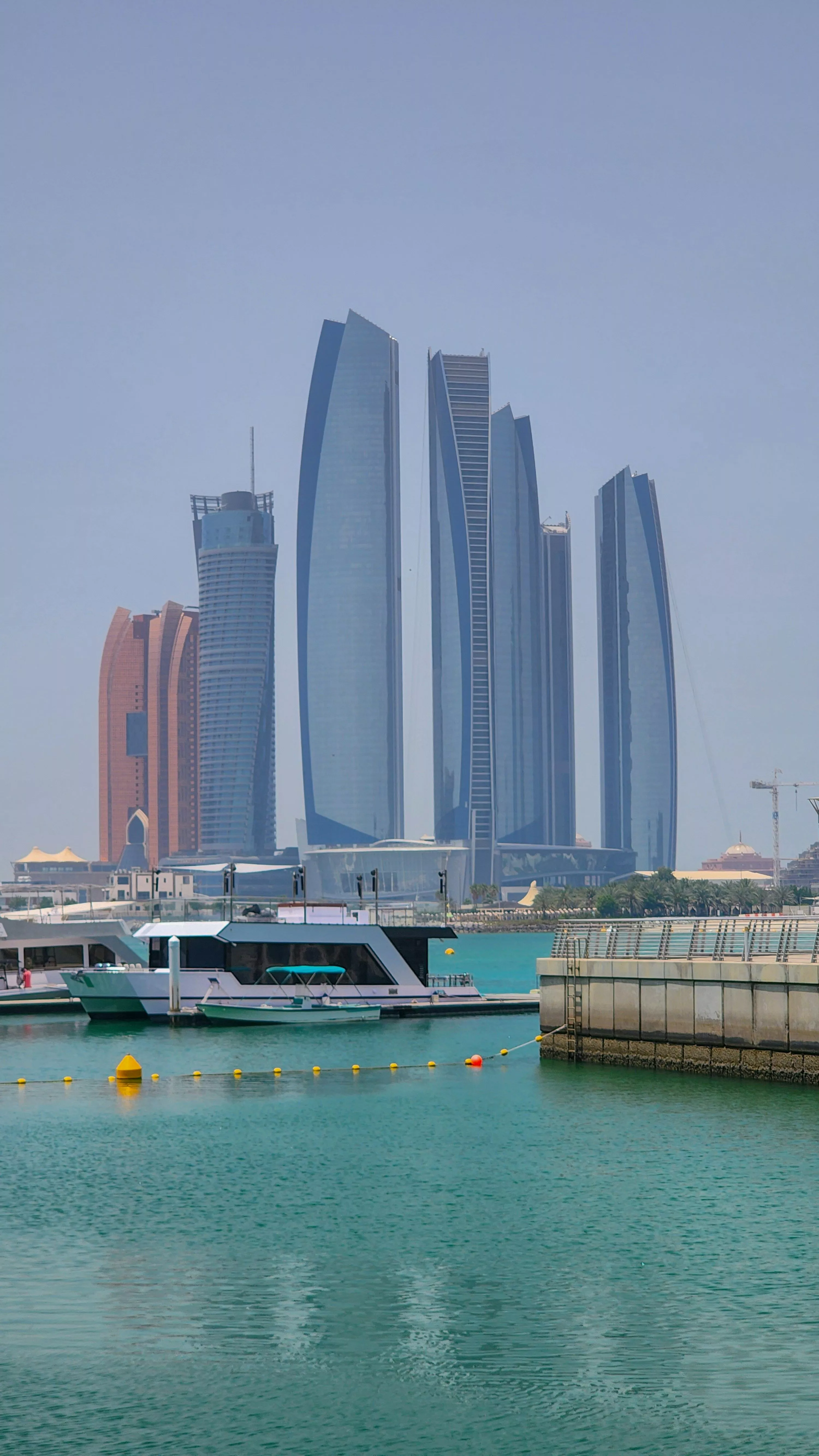 A boat in the water with tall buildings