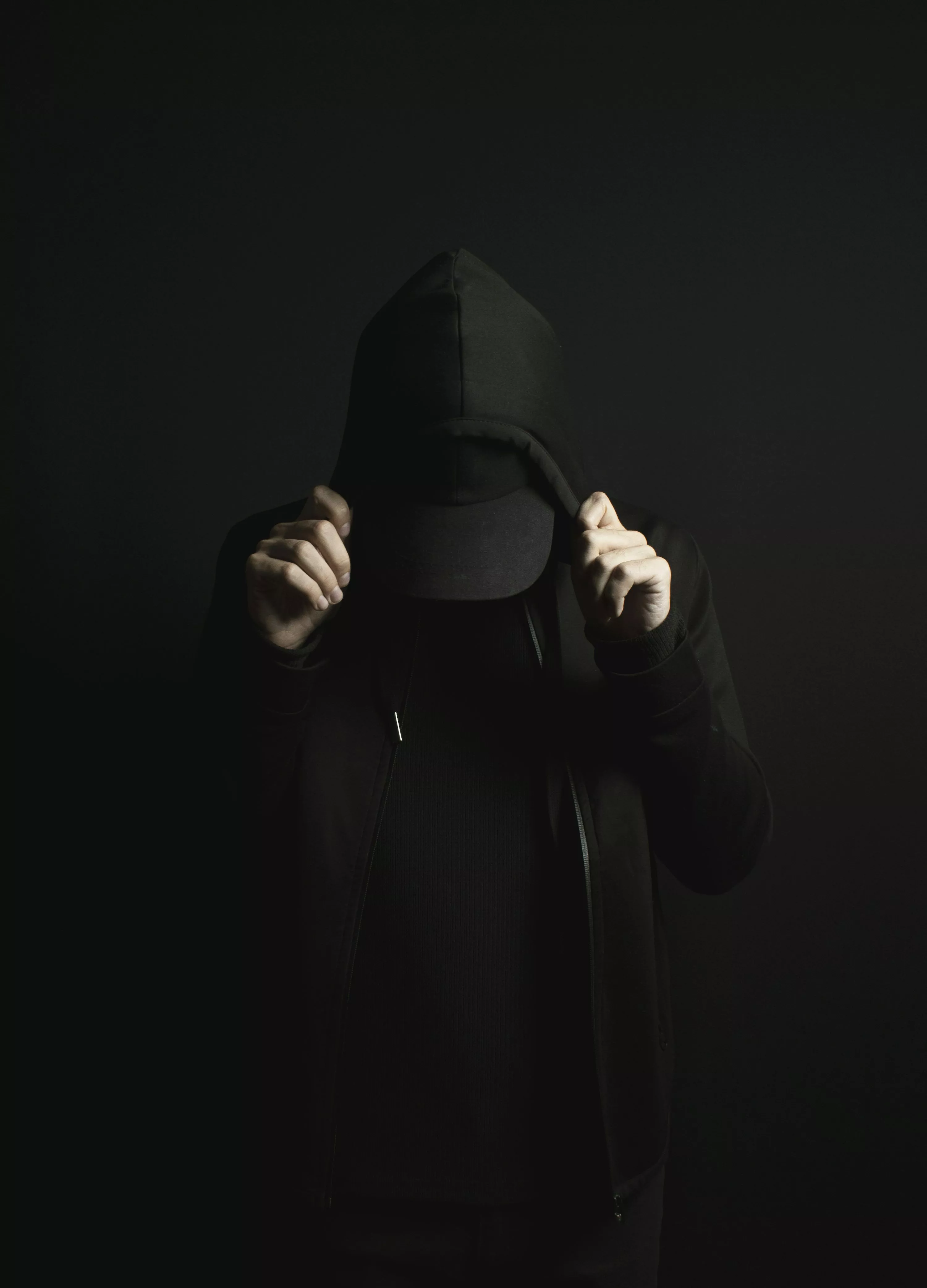black hoodie and a black hat