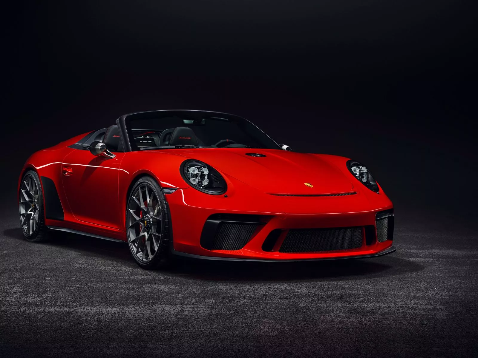 Red Porsche 911 convertible on a gray