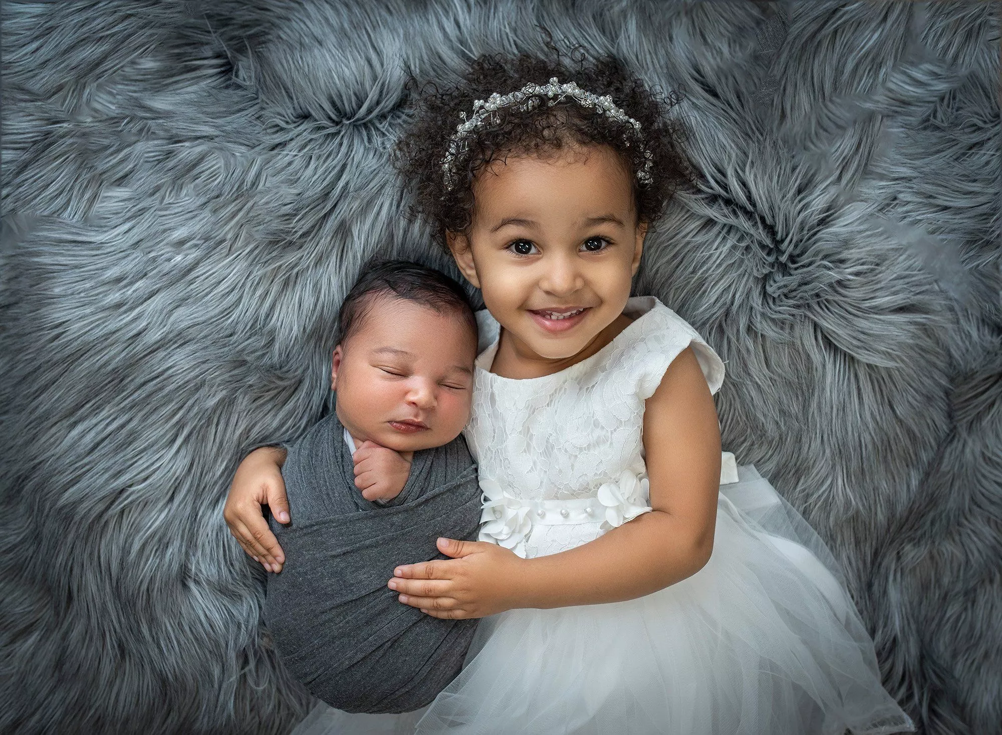 Newborn Smile with Big Sister Photo