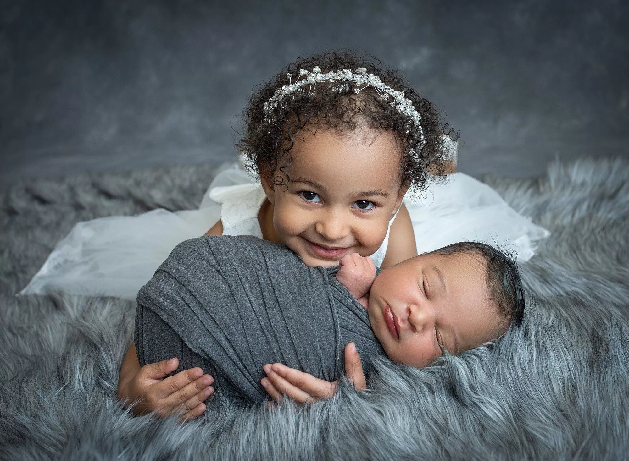 Newborn smile with big sister photo