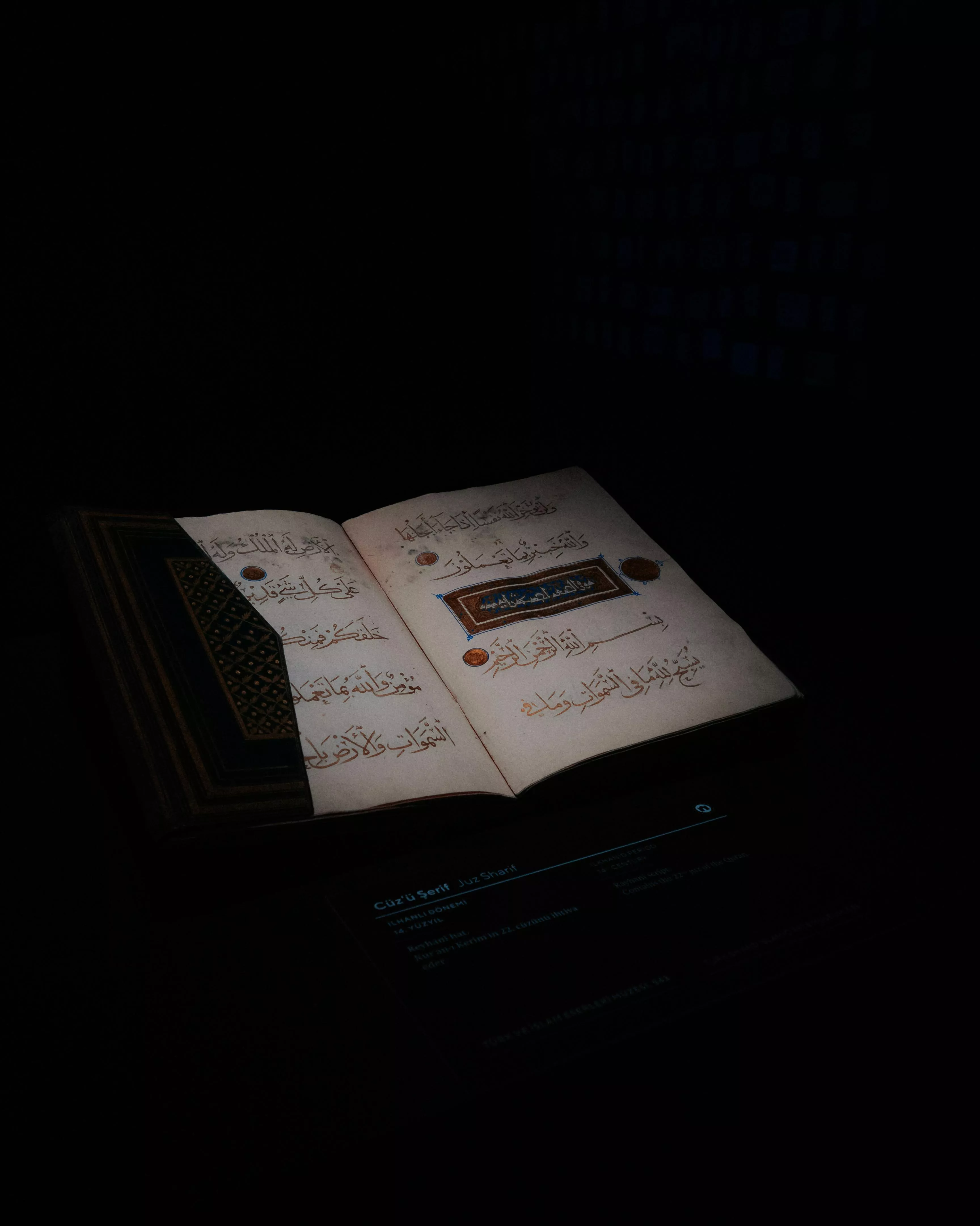 Open Pages of the Quran on a Black