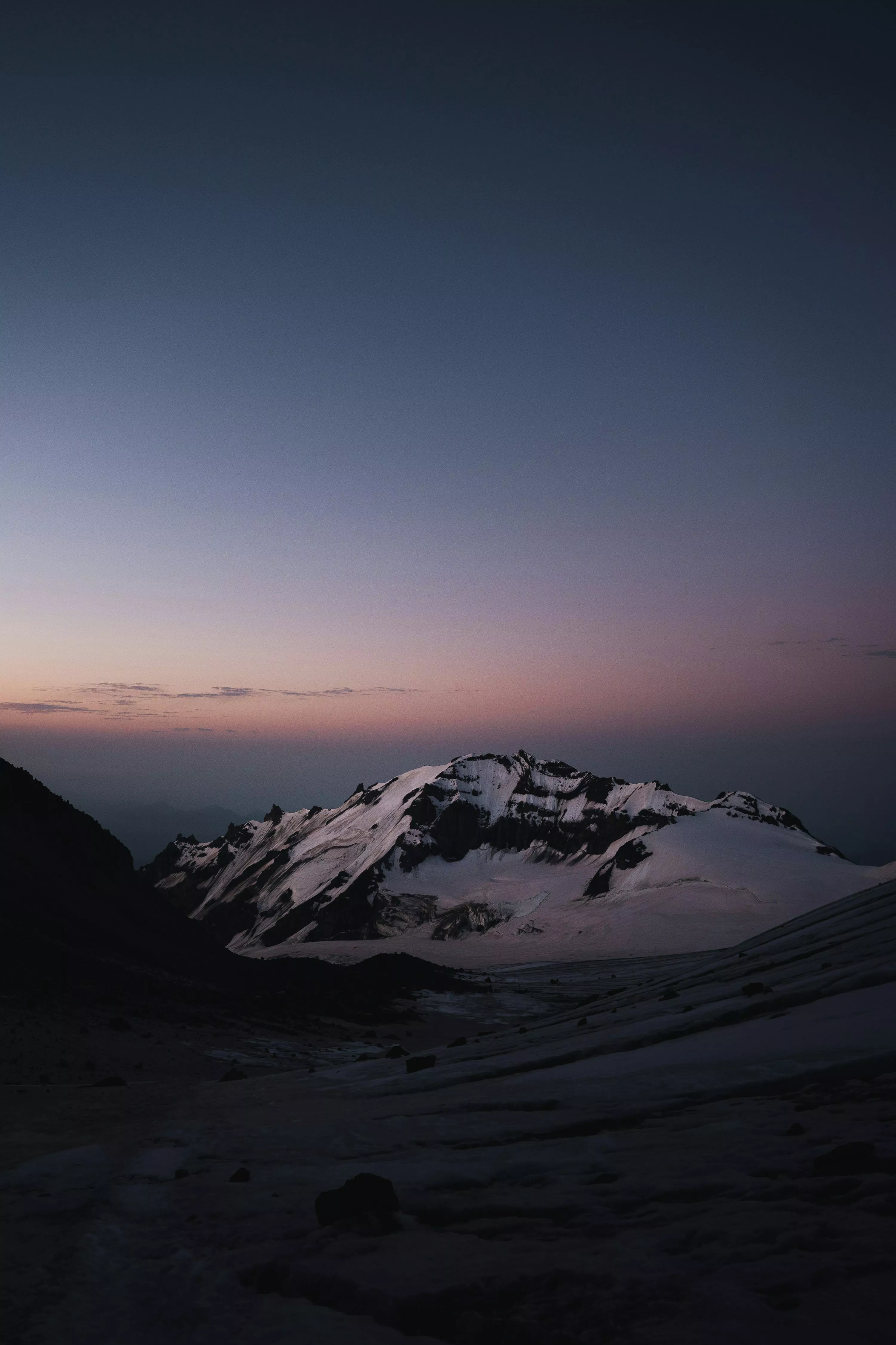 A snow covered mountain with a sky