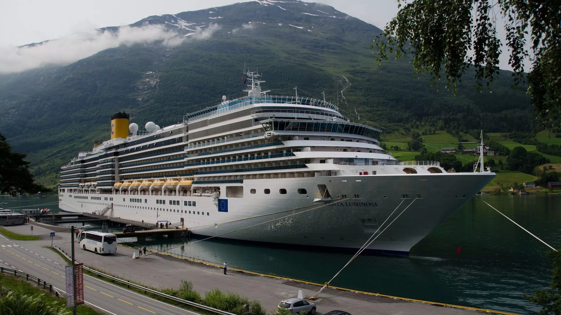 White Cruise Ship With Mountain